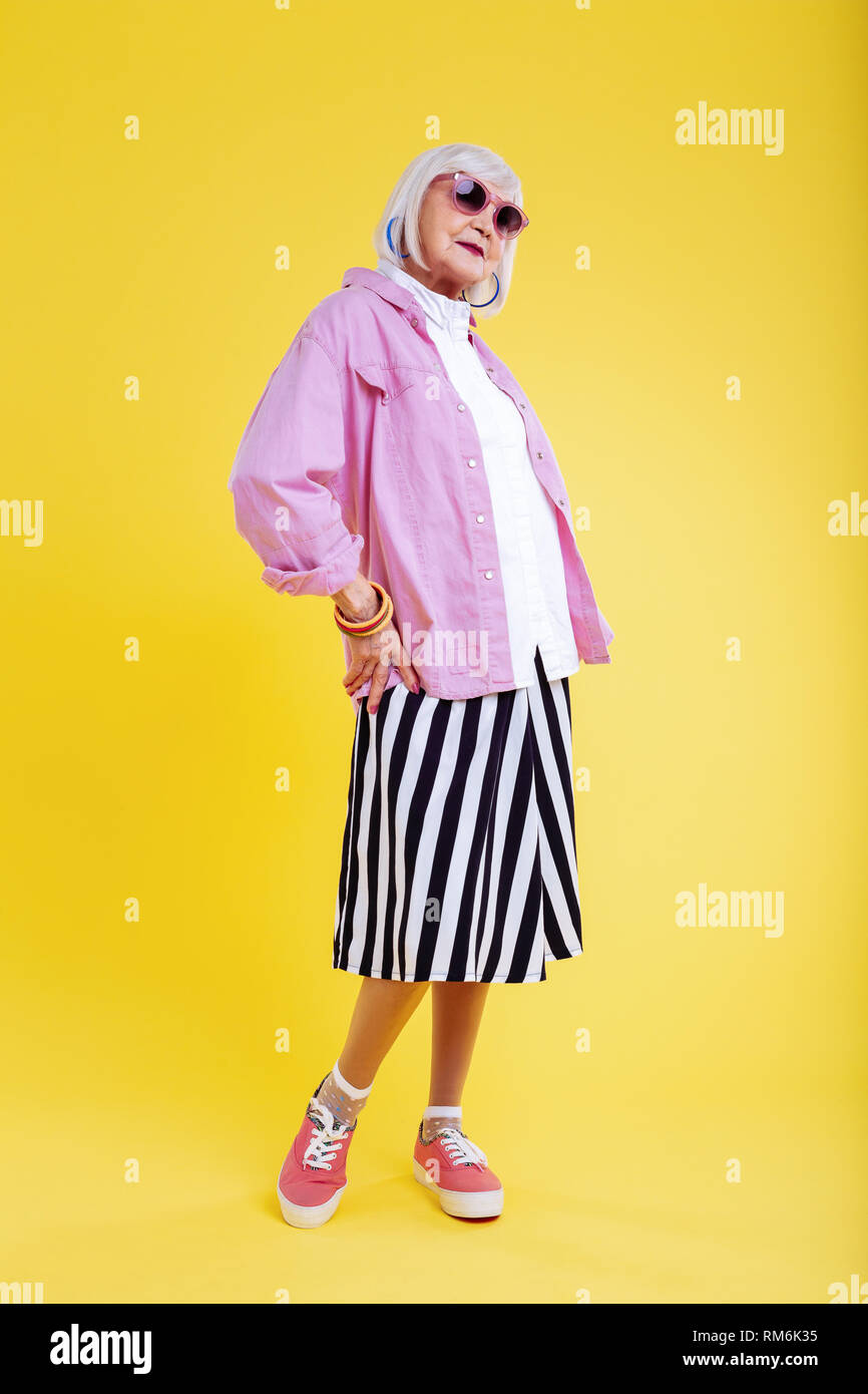 Stylish retired lady wearing striped white and black skirt Stock Photo