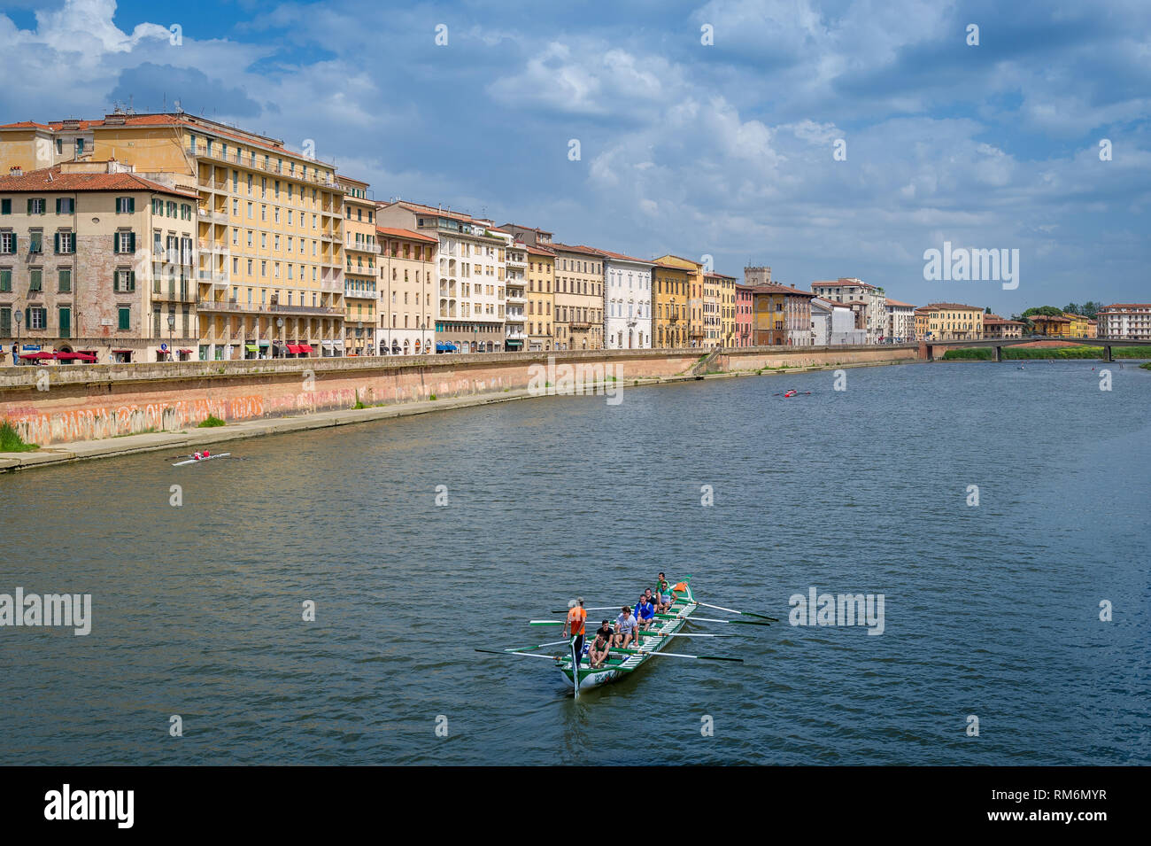 Arno river with canoe and Pisa embankment. Travel views of Toscana, Italy. Stock Photo