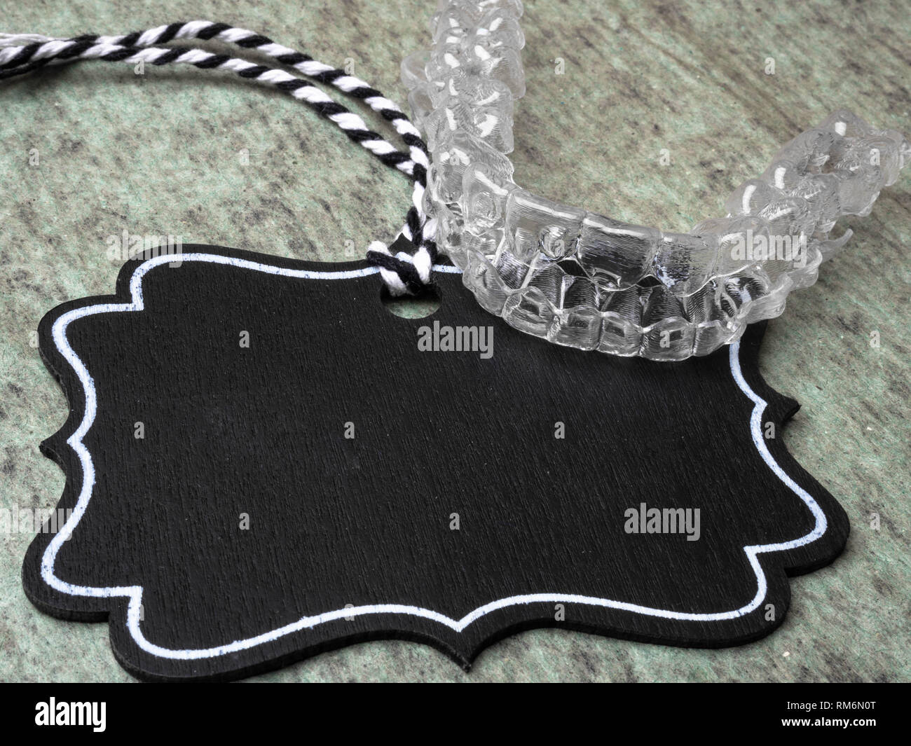 Invisalign braces. Invisible brackets with nameplate for text Stock