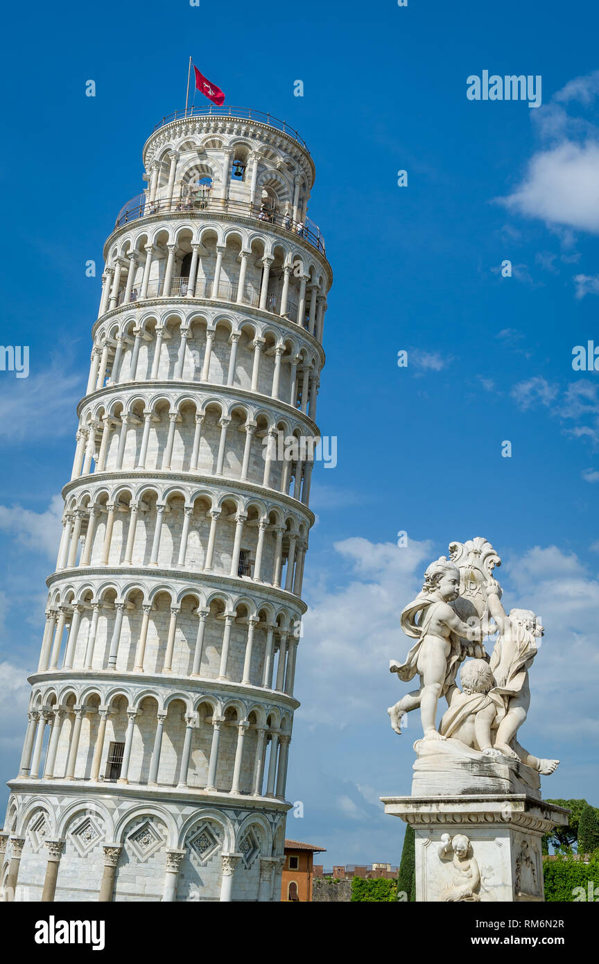 Vertical photo of famous Pisa Tower and Putti Fountain sculpture. Toscana travel attractions, Italy. Stock Photo