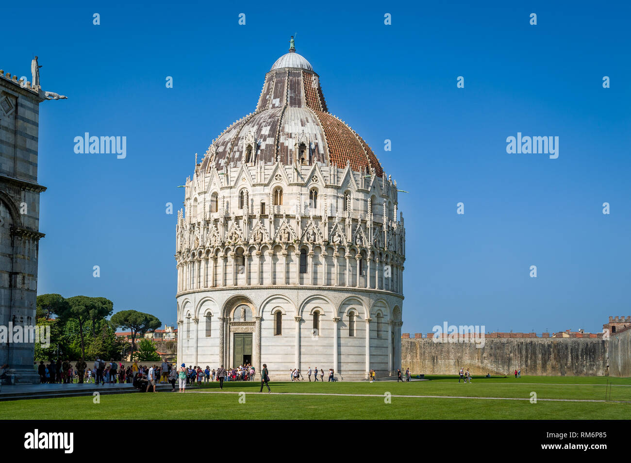 Tourist's queue to Pisa Baptistery - popular heritage of old Pisa. Tuscany, Italy. Stock Photo
