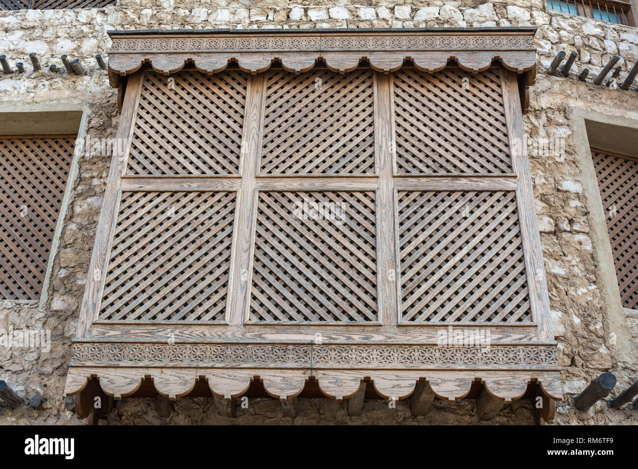 Traditional Arabic mashrabiya balcony enclosed with carved wood latticework in Doha, Qatar. Stock Photo