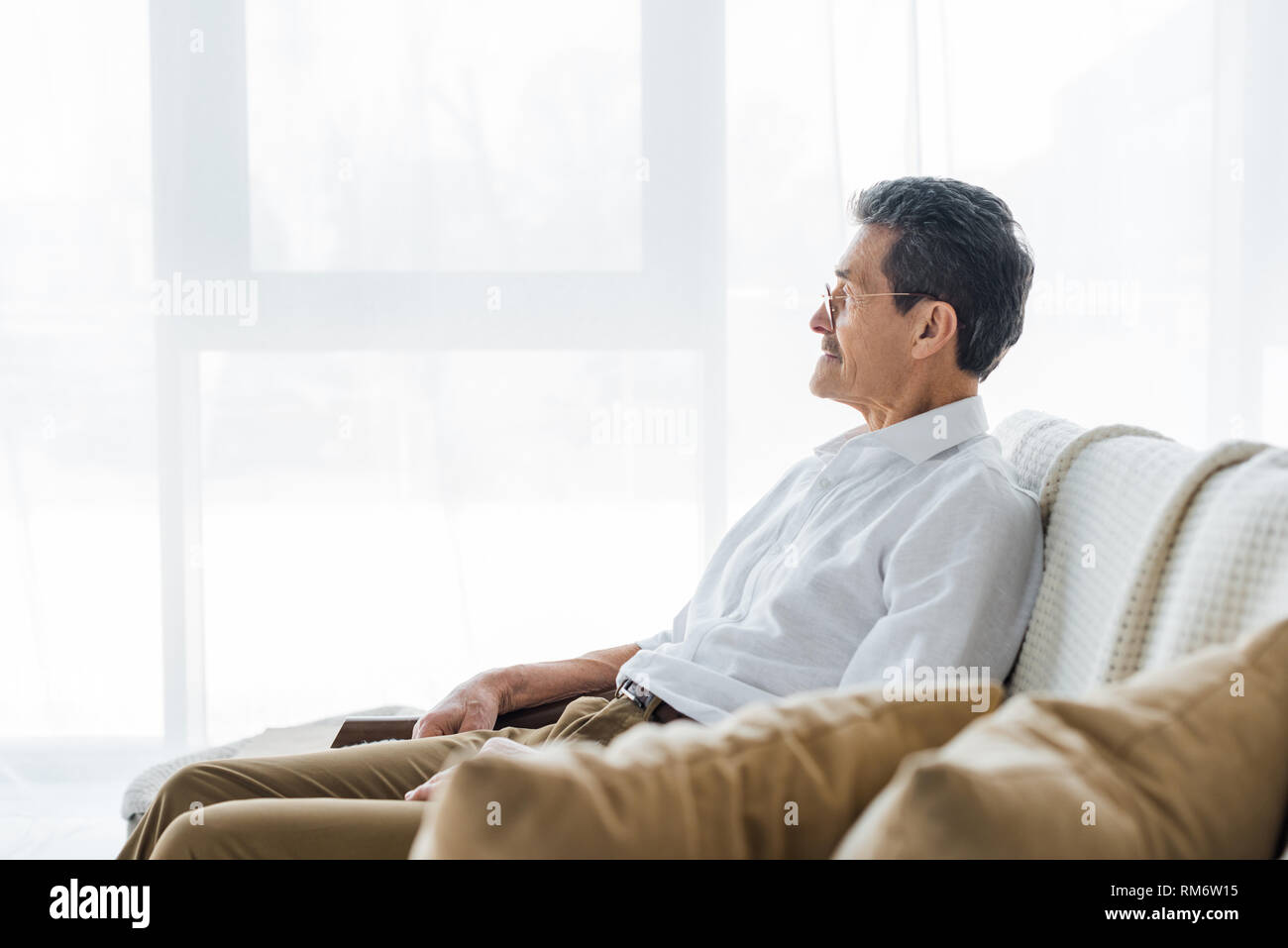 Thoughtful senior man sitting on hi-res stock photography and images ...
