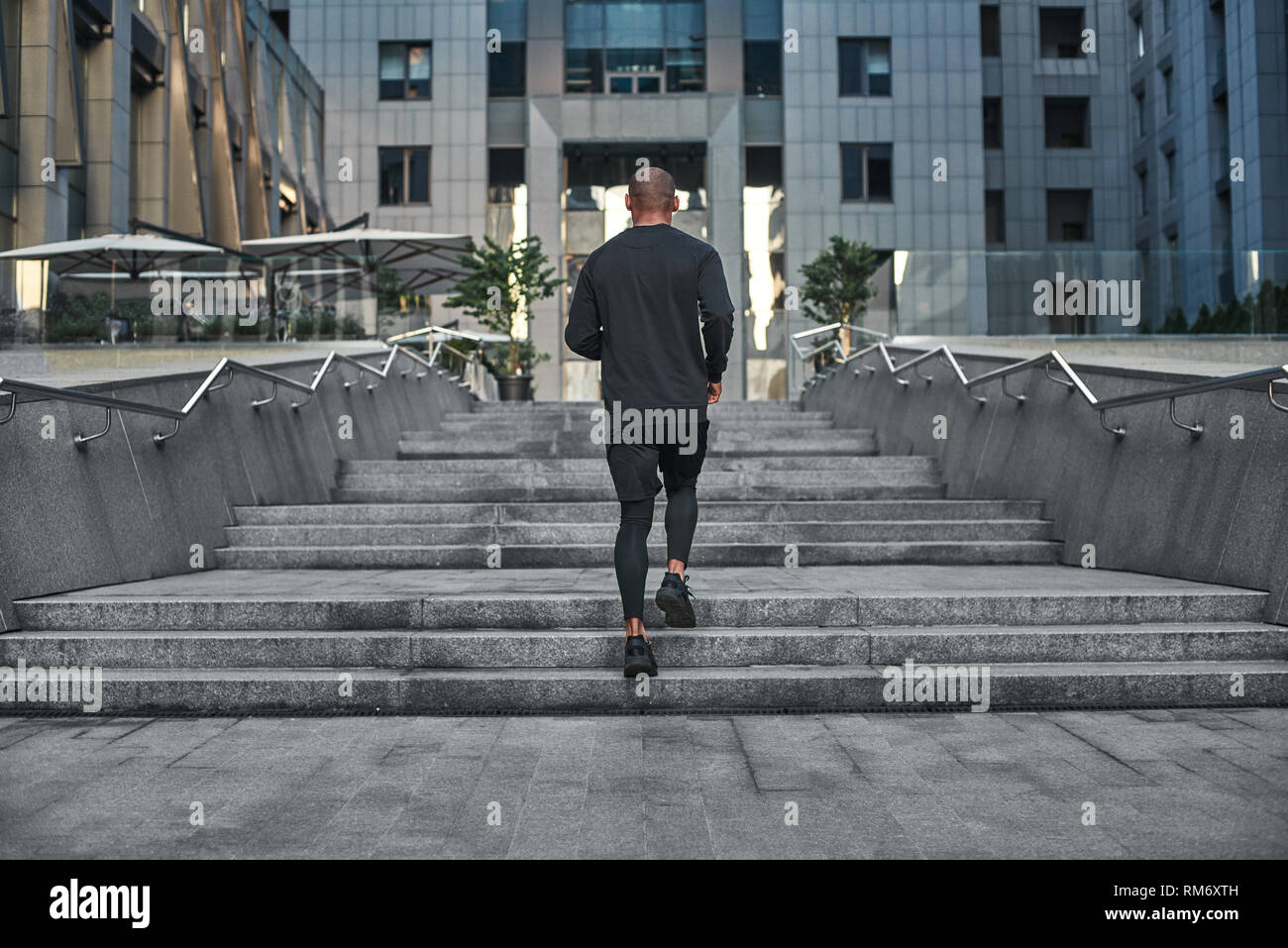 Black man running up stairs hi-res stock photography and images - Alamy