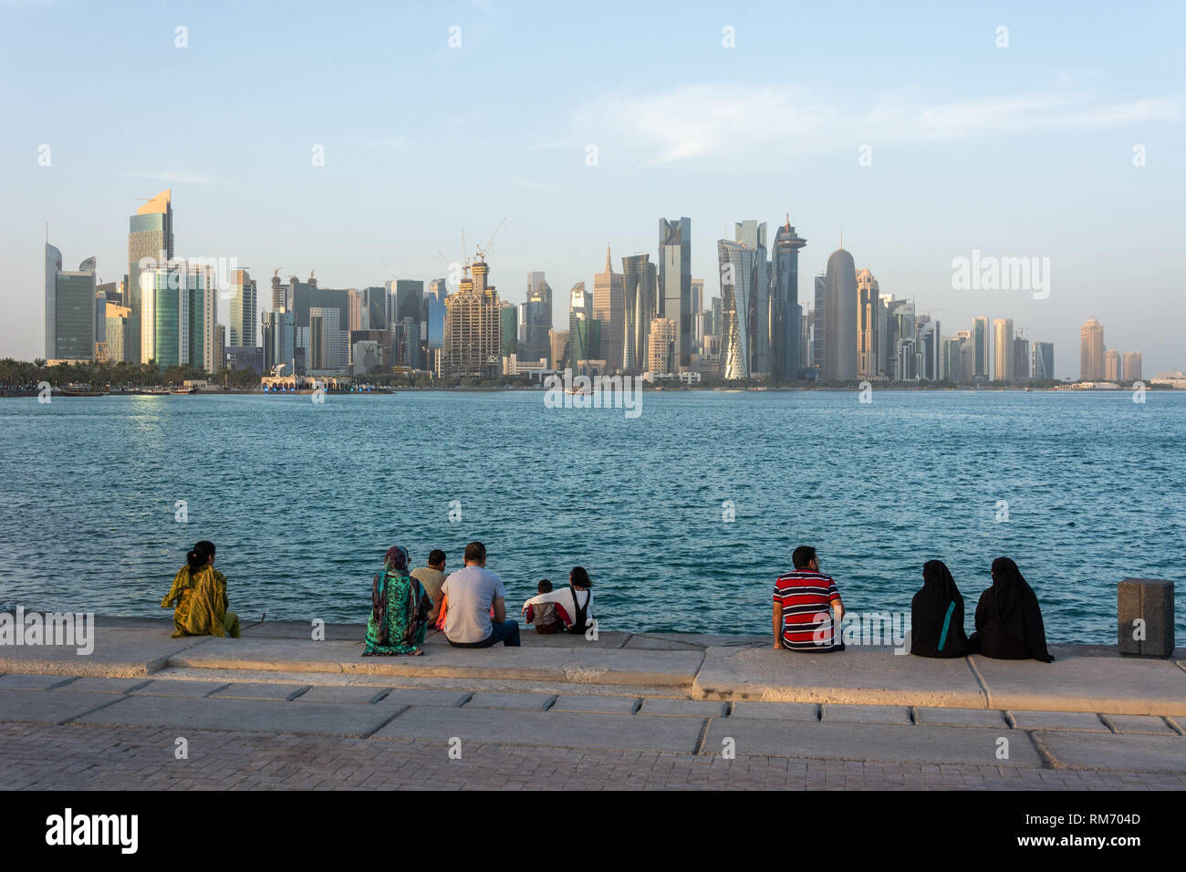 Doha, Qatar - November 4, 2016. Al Corniche waterfront in Doha, with families enjoying late afternoon and skyscrapers in the background. Stock Photo