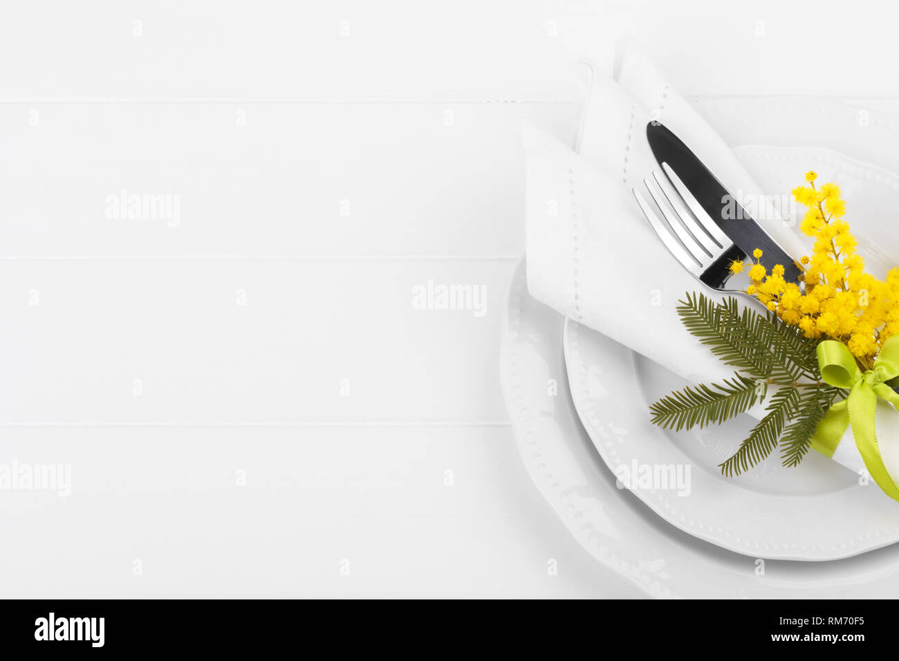 Spring table setting with mimosa easter holidays dinner Stock Photo