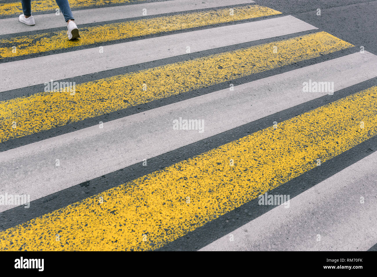 Crosswalk. White and yellow lines. Asphalt road. Security in the city. Stock Photo