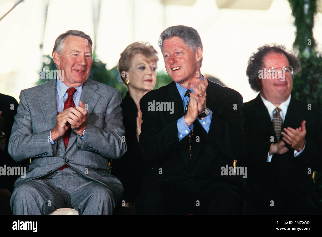 U.S. President Bill Clinton sits with Journalist Robert MacNeil, left, and Music Director of the Metropolitan Opera James Levine, right, during the National Medal of Arts and Humanities awards during a ceremony on the South Lawn of the White House September 29, 1997 in Washington, DC. Stock Photo