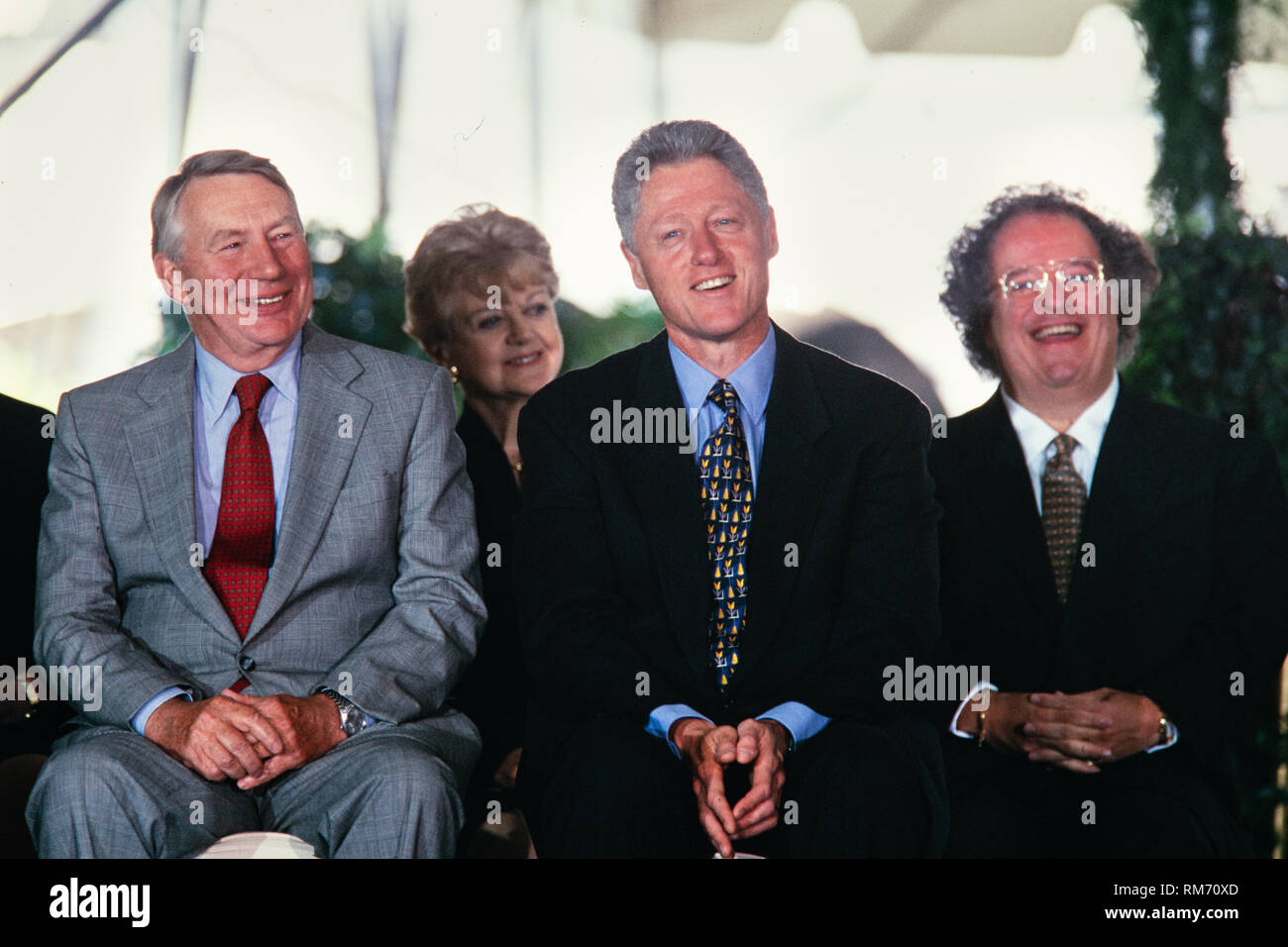 U.S. President Bill Clinton sits with Journalist Robert MacNeil, left, and Music Director of the Metropolitan Opera James Levine, right, during the National Medal of Arts and Humanities awards during a ceremony on the South Lawn of the White House September 29, 1997 in Washington, DC. Stock Photo