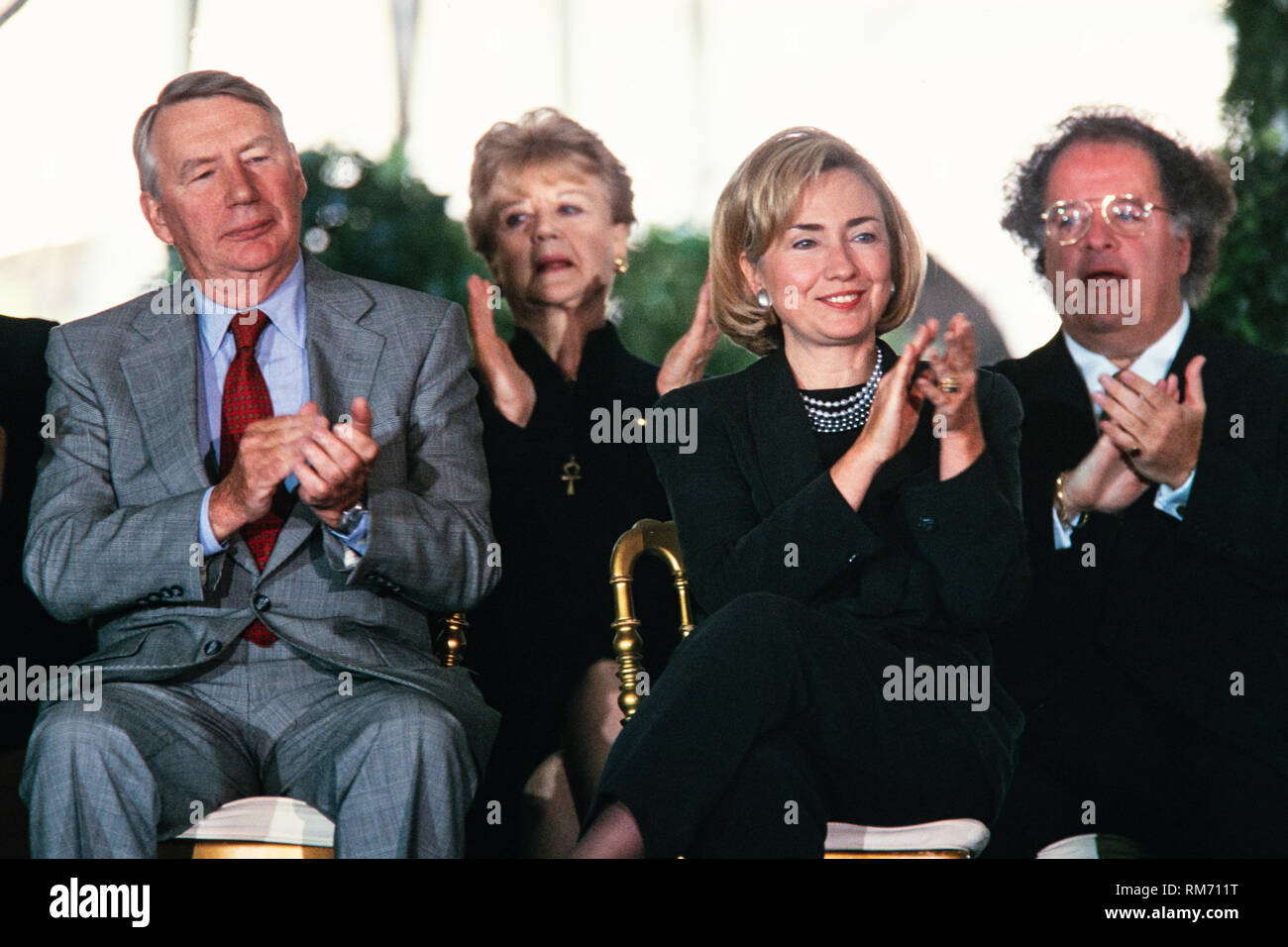 U.S. First Lady Hillary Clinton sits with Journalist Robert MacNeil, left, and Music Director of the Metropolitan Opera James Levine, right, during the National Medal of Arts and Humanities awards during a ceremony on the South Lawn of the White House September 29, 1997 in Washington, DC. Stock Photo