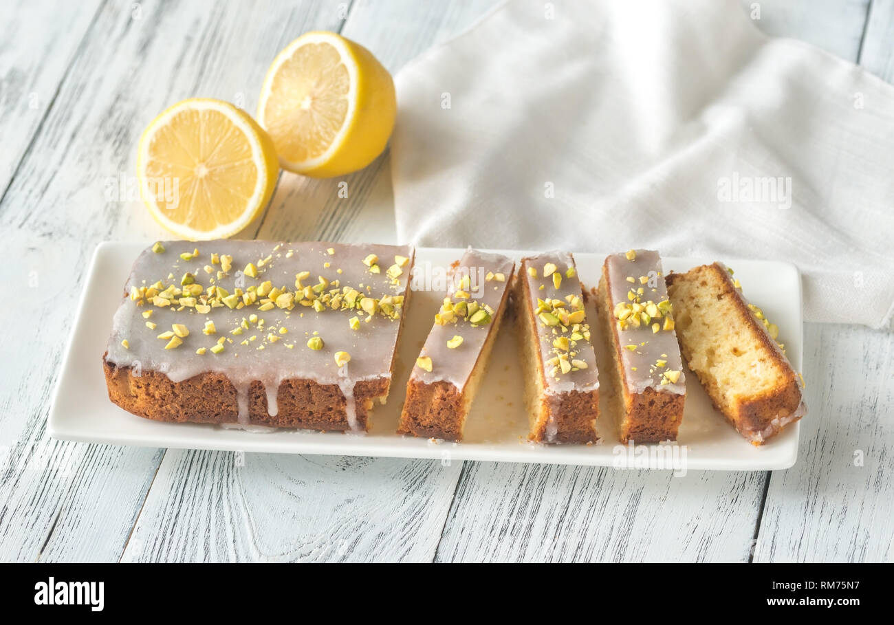 Lemon cake with icing decorated with pistachios: top view Stock Photo