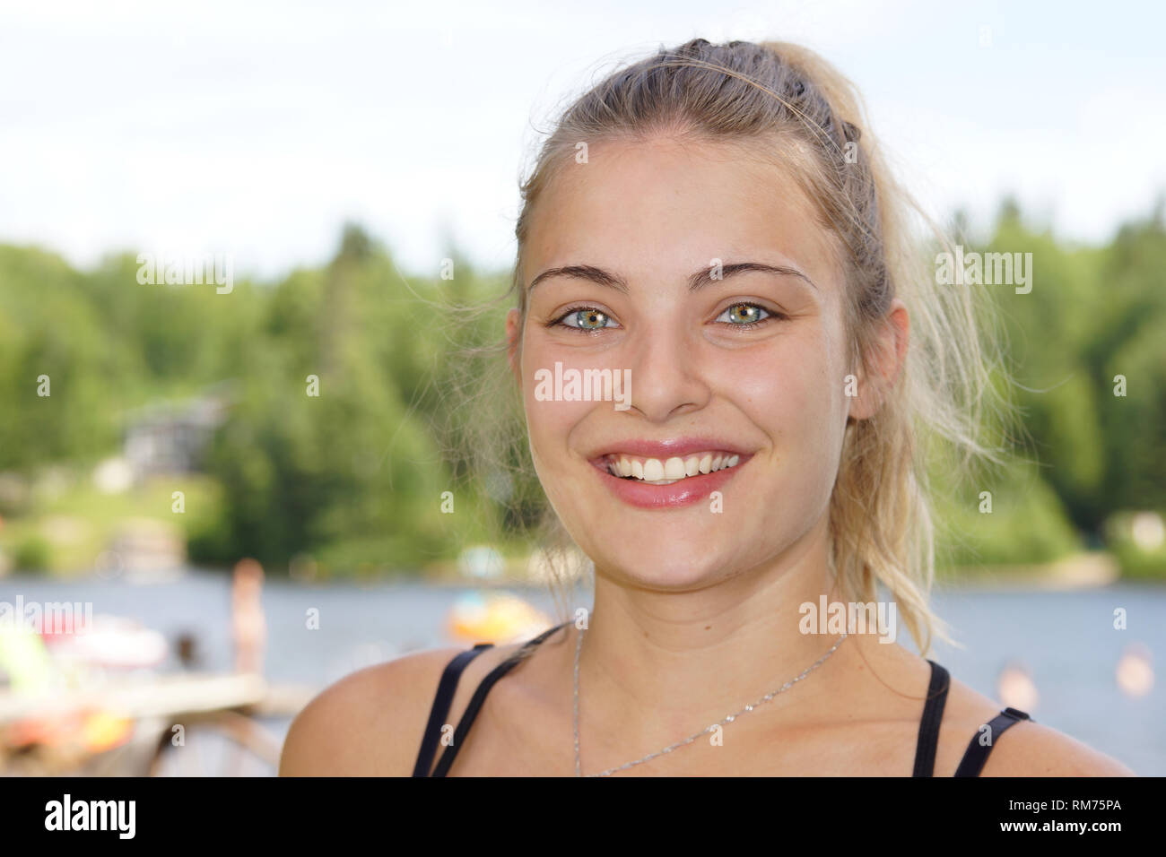 Portrait of beautiful young blond woman with stunning eyes outdoor Stock Photo