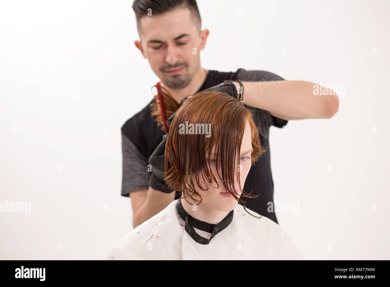 Barber Is Trimming Client S Hair With Scissors Stock Photo