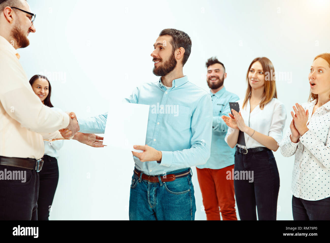 Boss approving and congratulating young successful employee of the company for his successes and good work. National Employee Appreciation Day, businesswoman, businessman, business, success, admire, career growth concept. Stock Photo