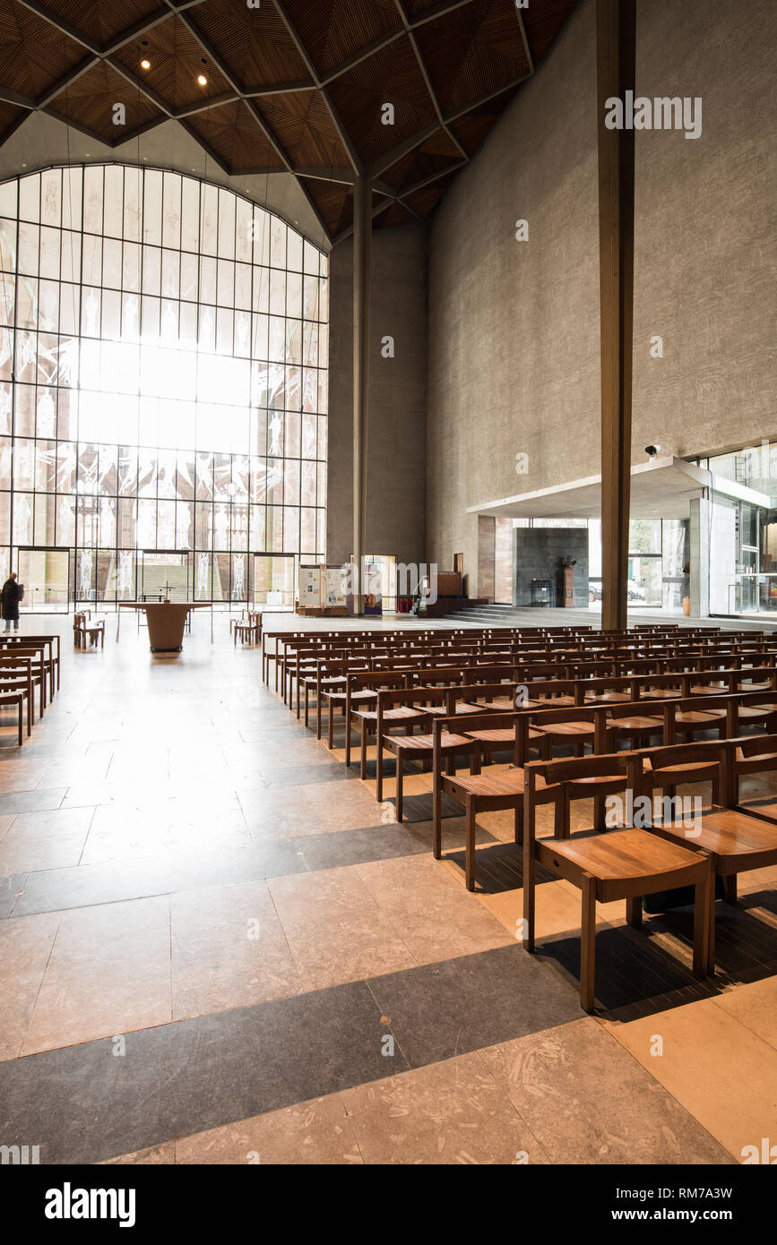 Nave with chairs at Coventry cathedral, England, looking towards the south end and the glass window with etchings of angels by th eartist John Hutton. Stock Photo