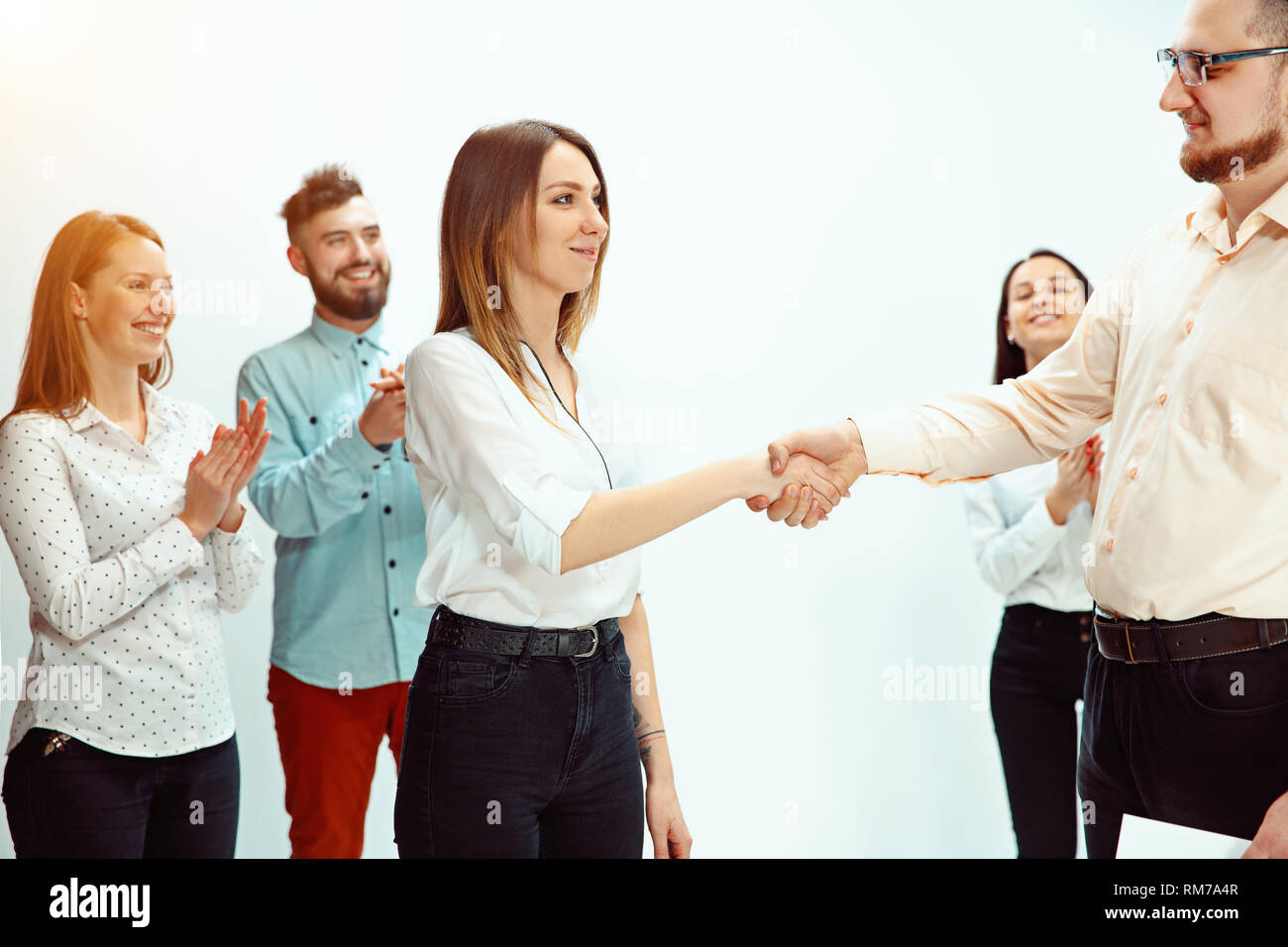 Boss approving and congratulating young successful employee of the company for her successes and good work. National Employee Appreciation Day, businesswoman, businessman, business, success, admire, career growth concept. Stock Photo