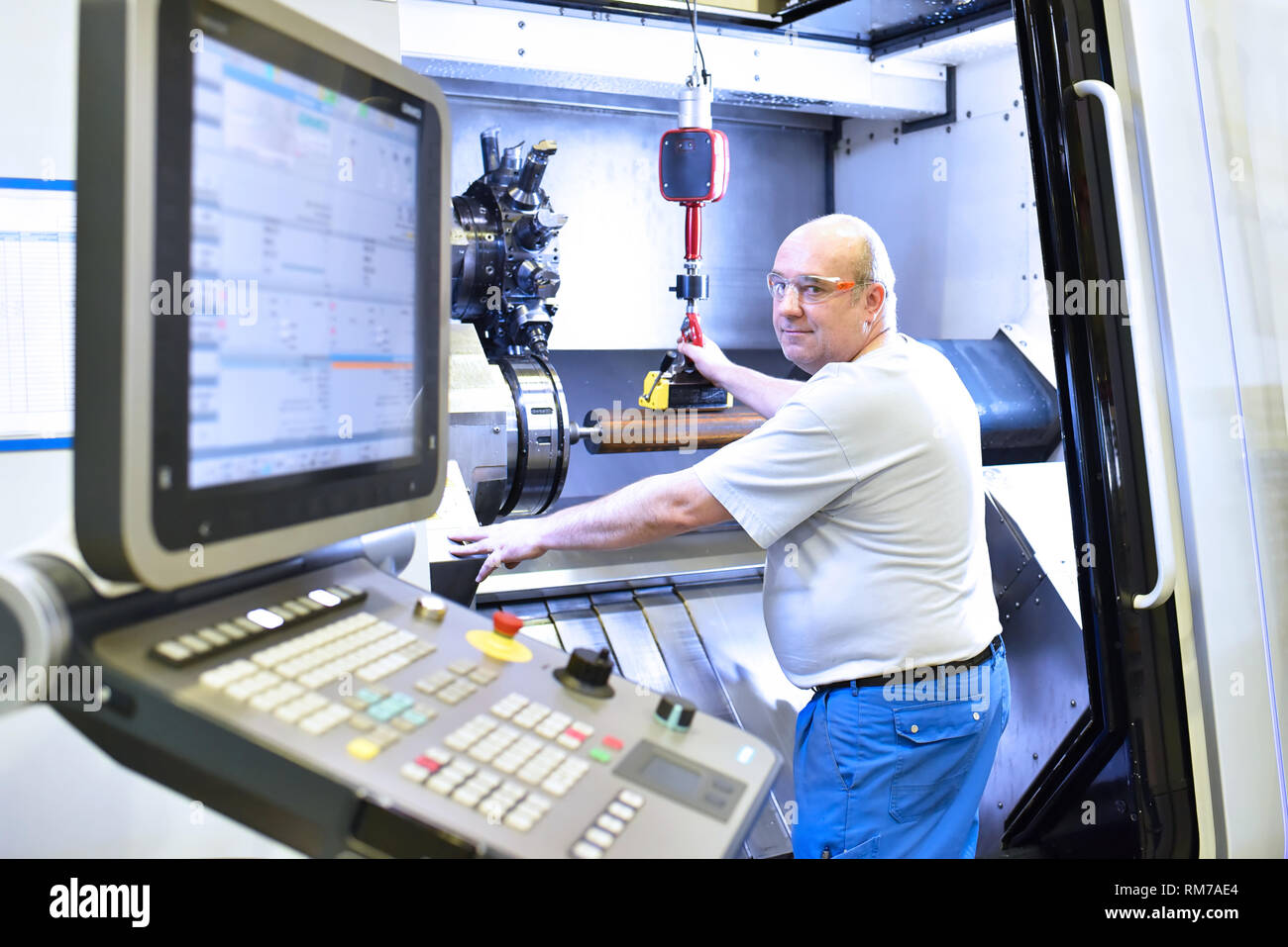 cnc machine in modern industrial mechanical engineering workers at