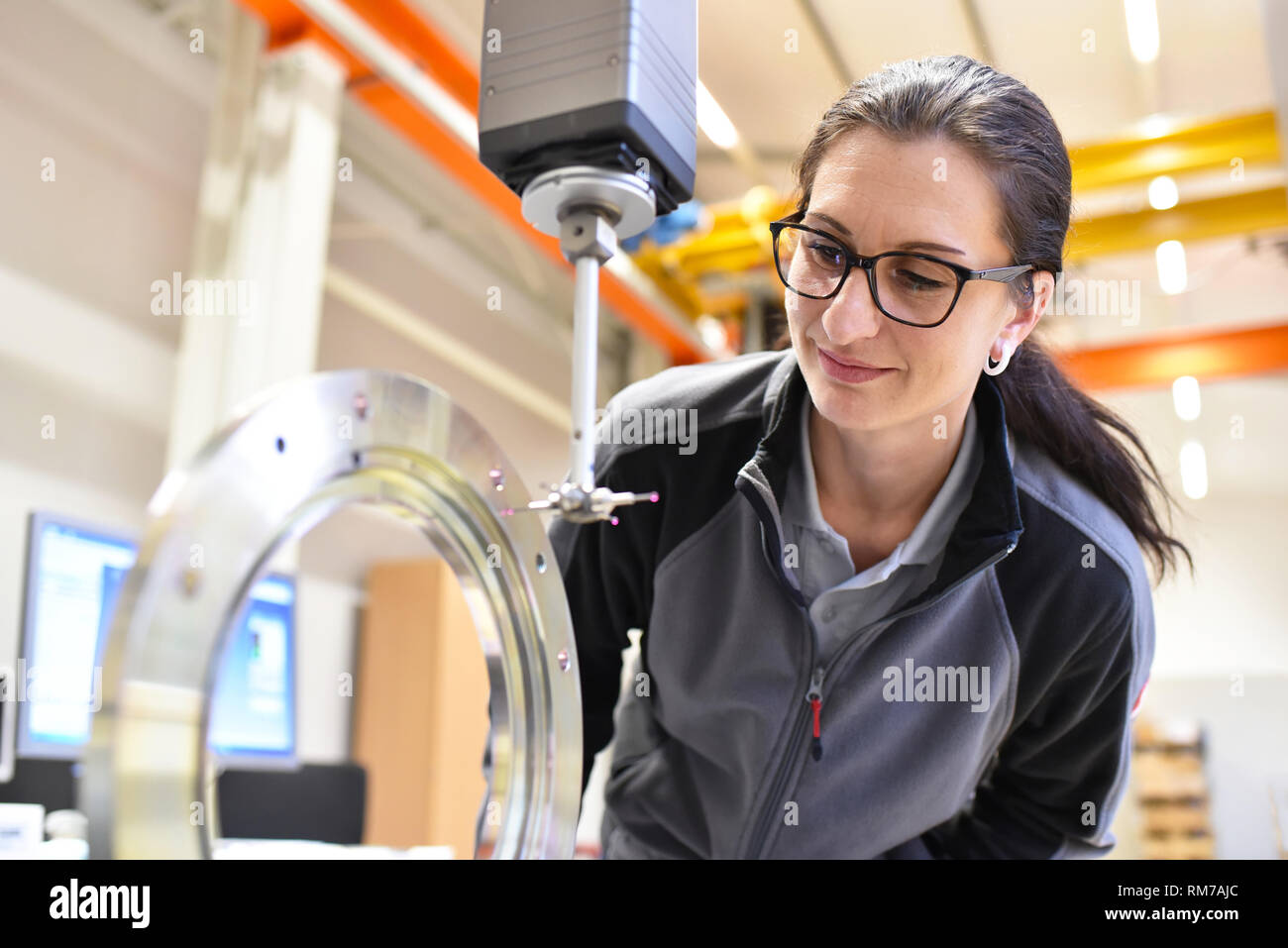 woman working in the quality control in the industry - measurement of a workpiece Stock Photo