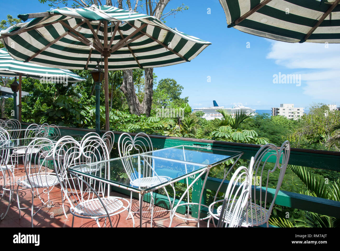 The empty cafe veranda with an aerial view toward the cruise ship in