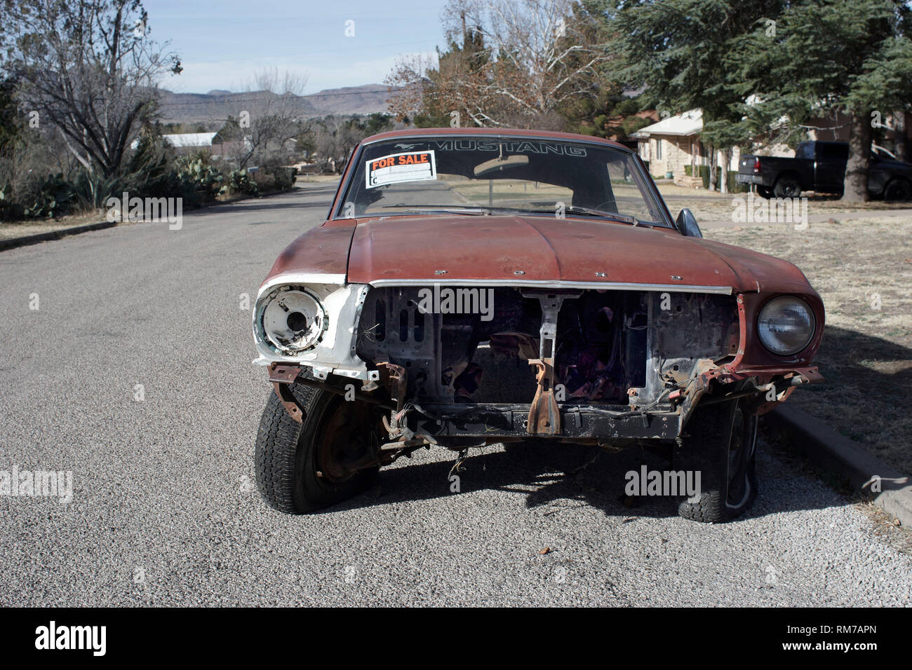 Old Ford Mustang , without engine and in overall poor condition, for sale in a street of Alpine, Texas. Stock Photo