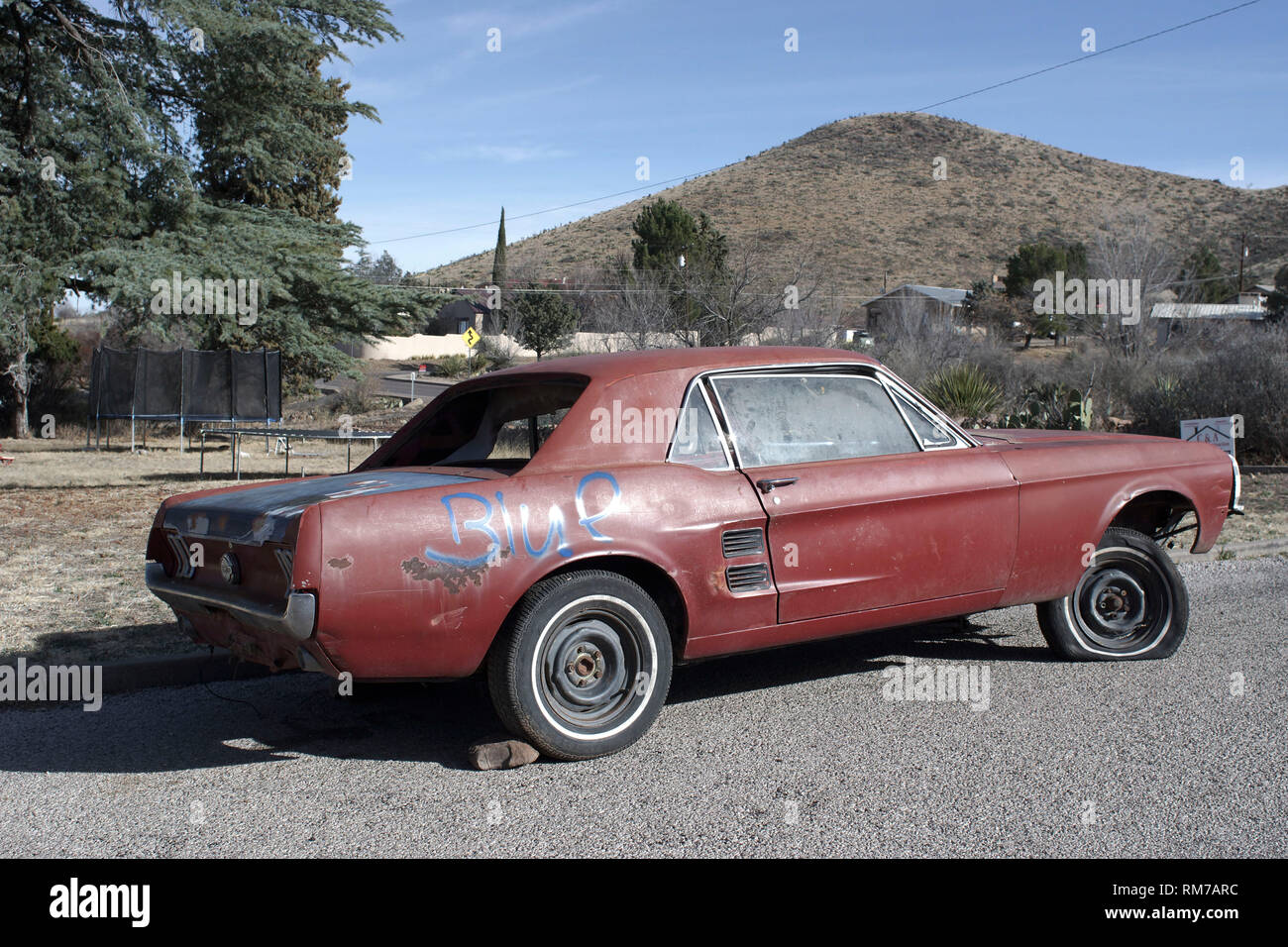 Old Ford Mustang , without engine and in overall poor condition, for sale in a street of Alpine, Texas. Stock Photo