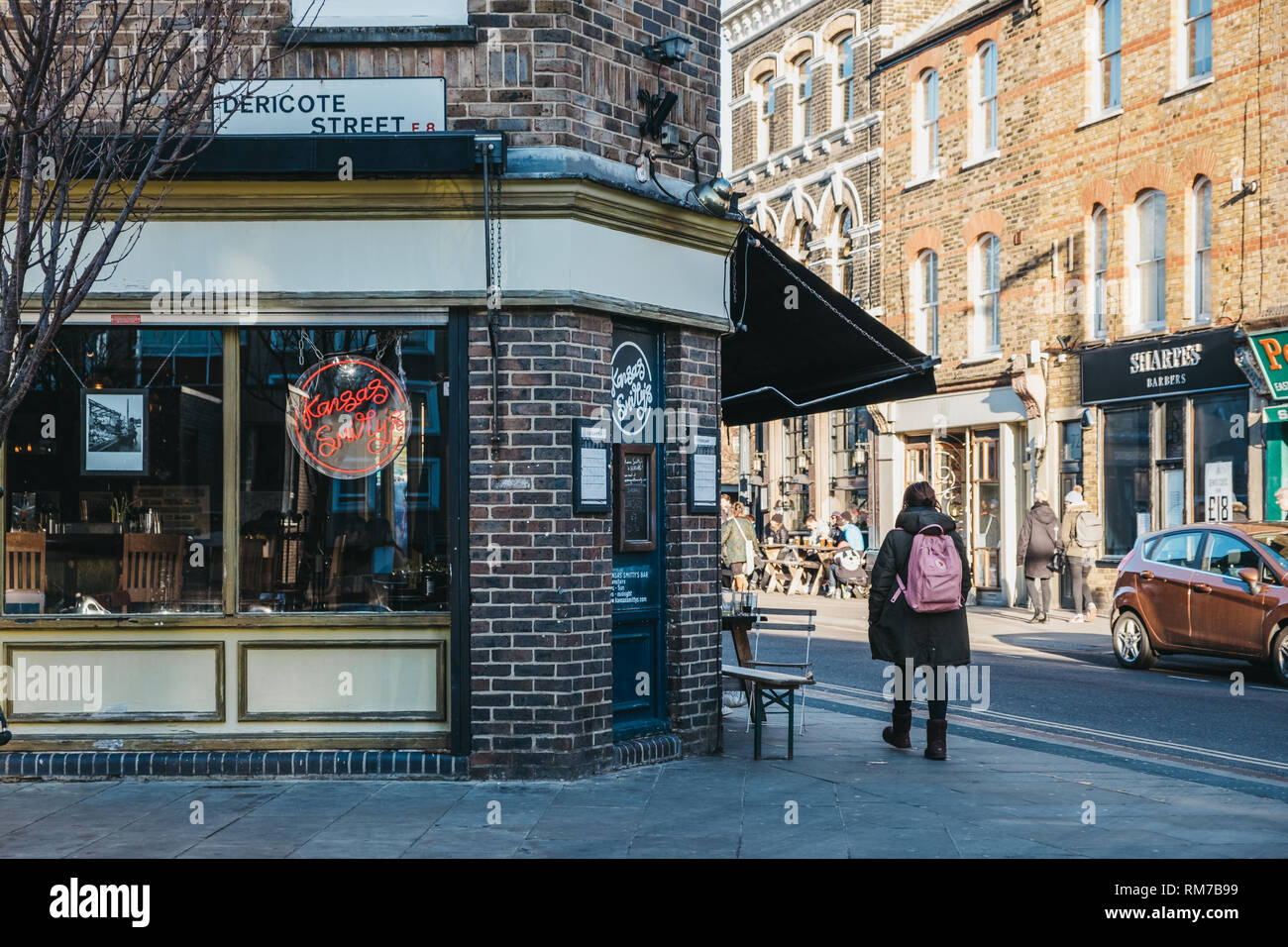 London, UK - February 03, 2019: People walking past shops and cafes on Broadway Market, a shopping street in the heart of Hackney, East London, UK. Stock Photo
