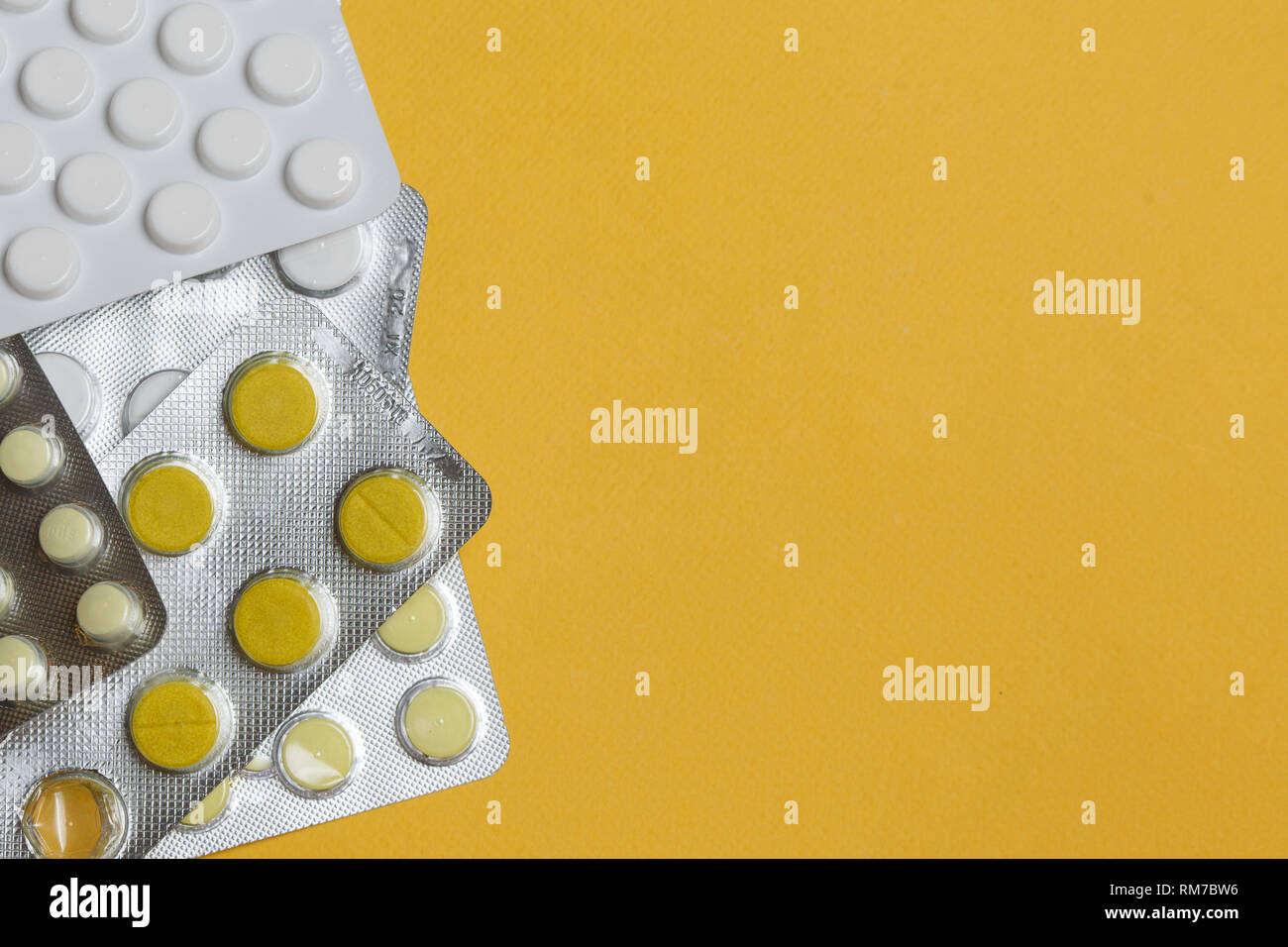 Medication round tablets arranged abstract on yellow color background