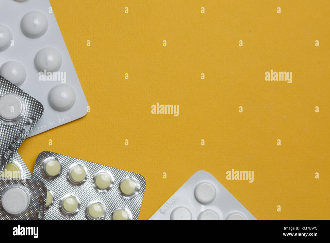 Medication round tablets arranged abstract on yellow color background