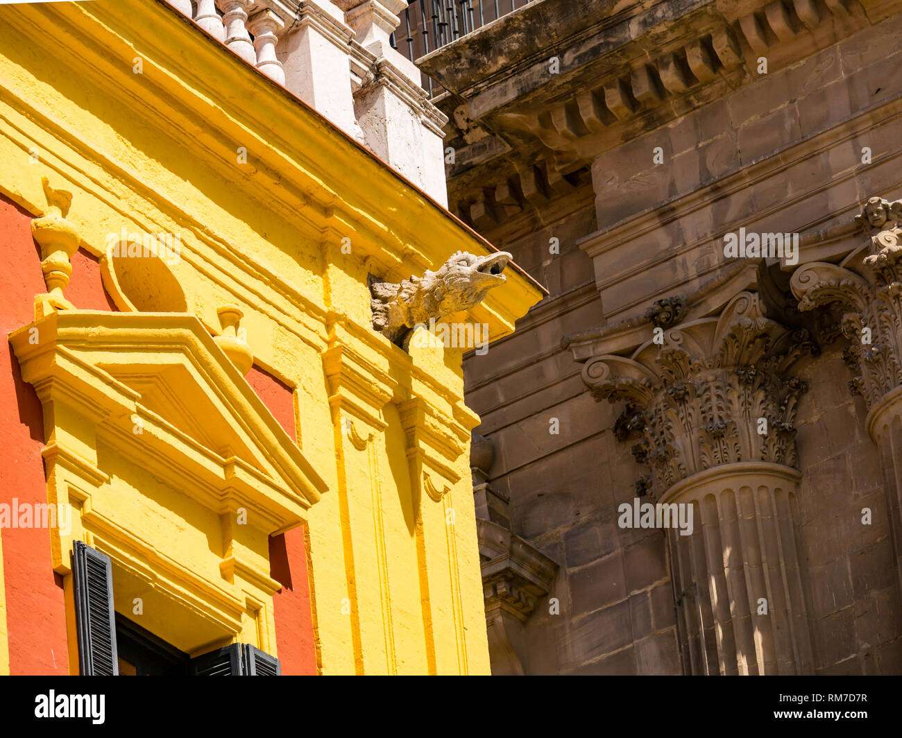 Episcopal Palace gargoyle in Plaza Obispo, with Cathedral Basilica, Malaga, Andalusia, Spain Stock Photo