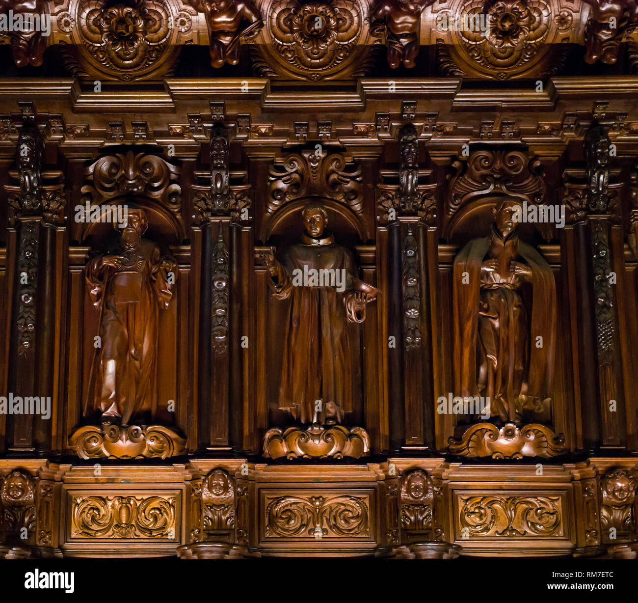 Carved religious wooden figures by Pedro de Mena, choir seats, Malaga Cathedral, Andalusia, Spain Stock Photo