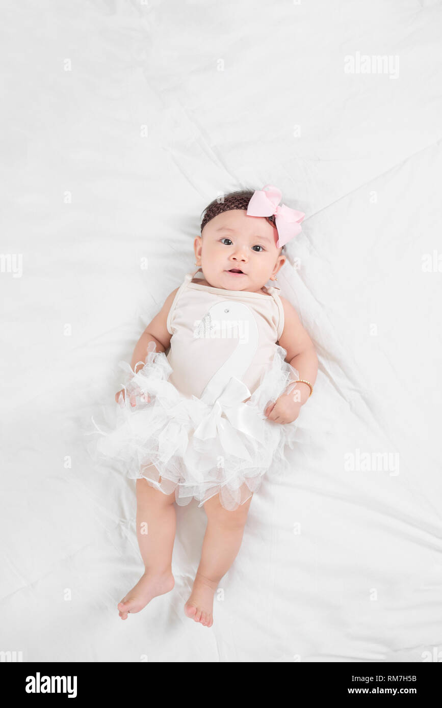 Asian baby girl laying on floor Stock Photo