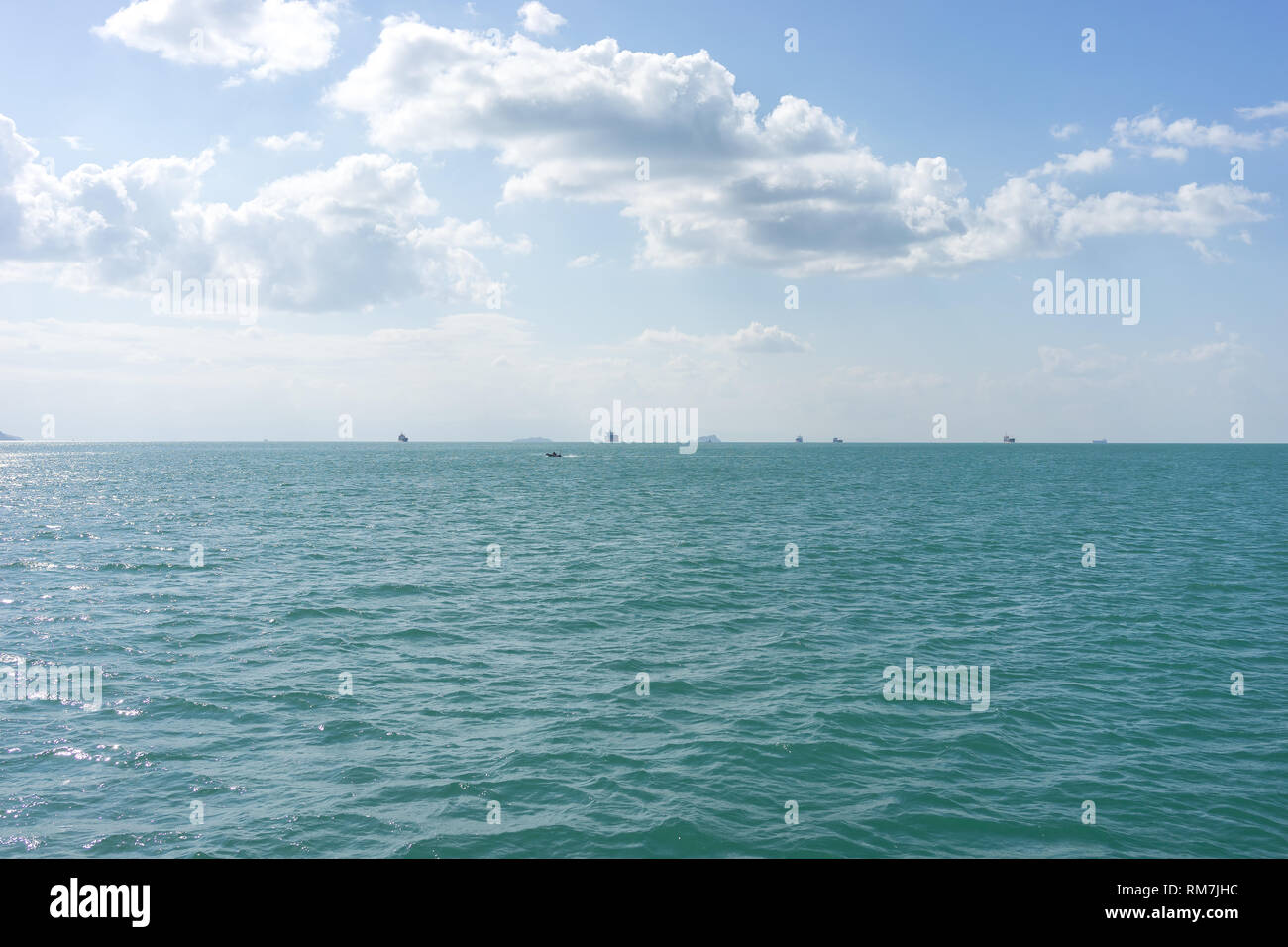 Ships in the raid on the horizon under the clouds Stock Photo