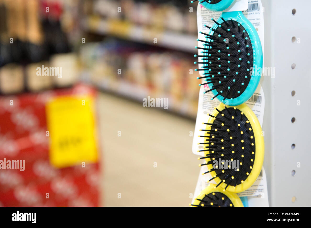 Colored hair brushes are sold. Combs for hair on a stand in a