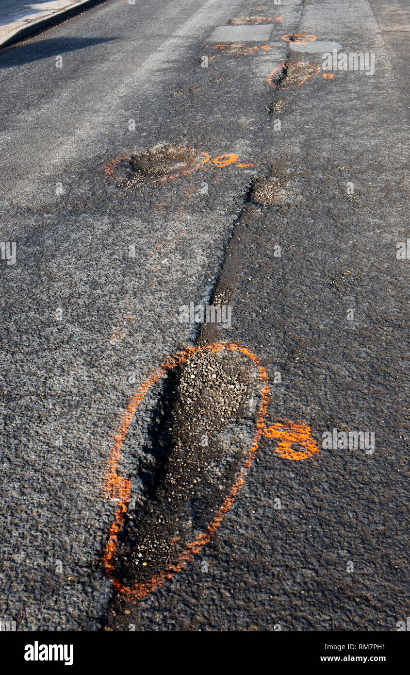Pot Holes or Potholes on Newbiggen Street, Thaxted Essex England UK
