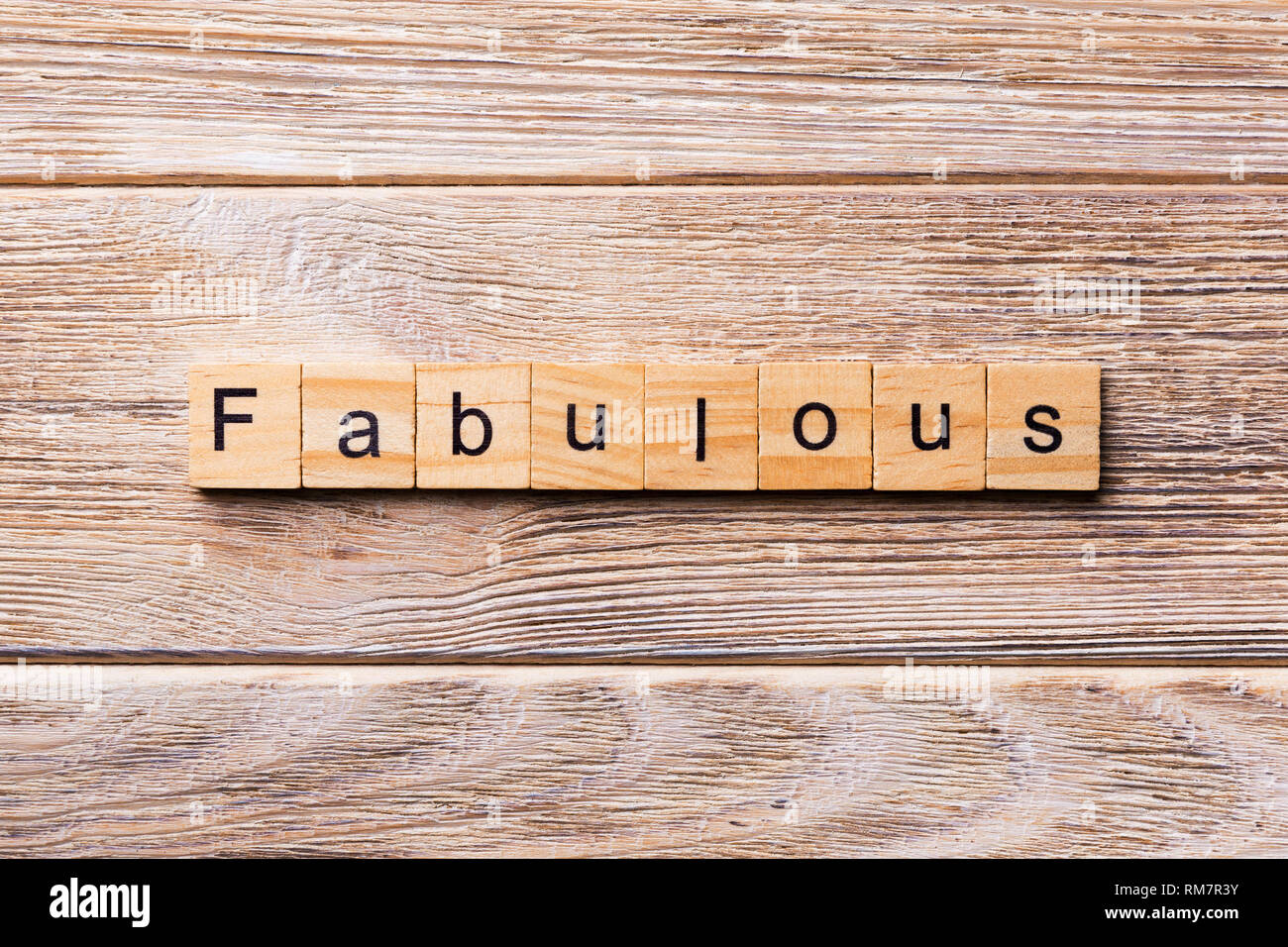 Fabulous word written on wood block. Fabulous text on wooden table for
