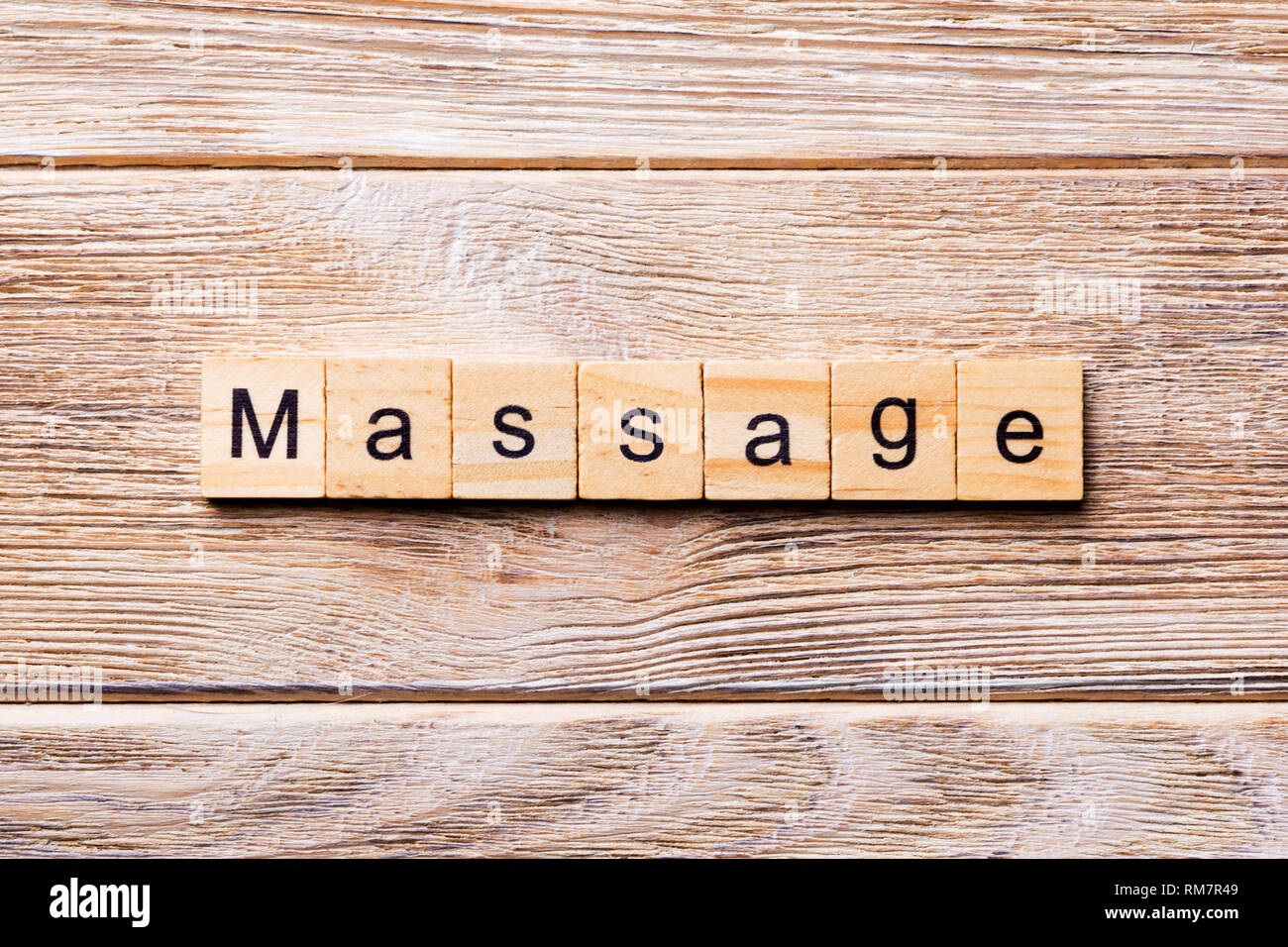 massage word written on wood block. massage text on wooden table for