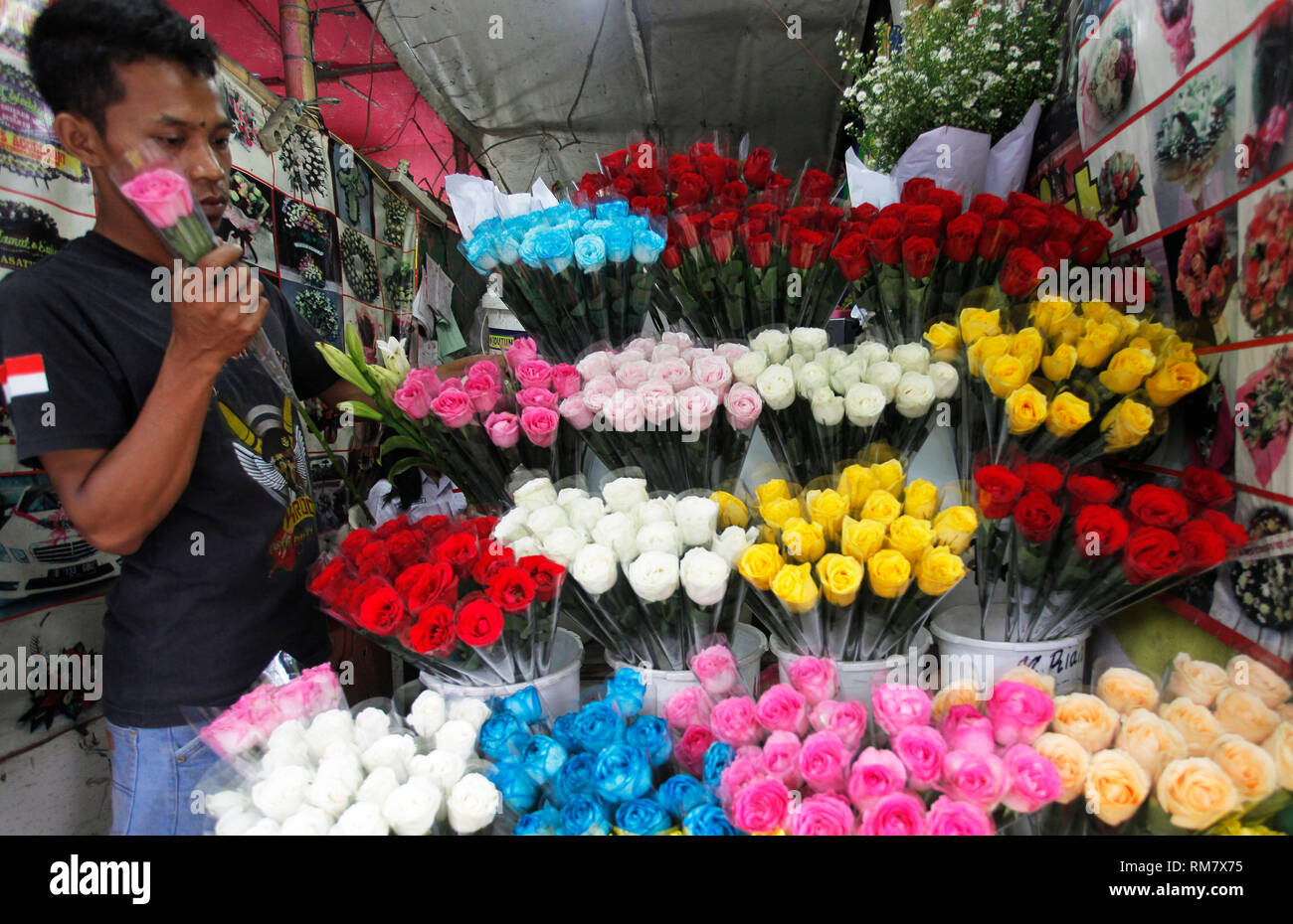 A seller is seen arranging flowers at one of the flower and coral flower shops. Ahead of the Valentine's Day commemoration, flower shops began to be visited by buyers to express affection to their loved ones. Stock Photo