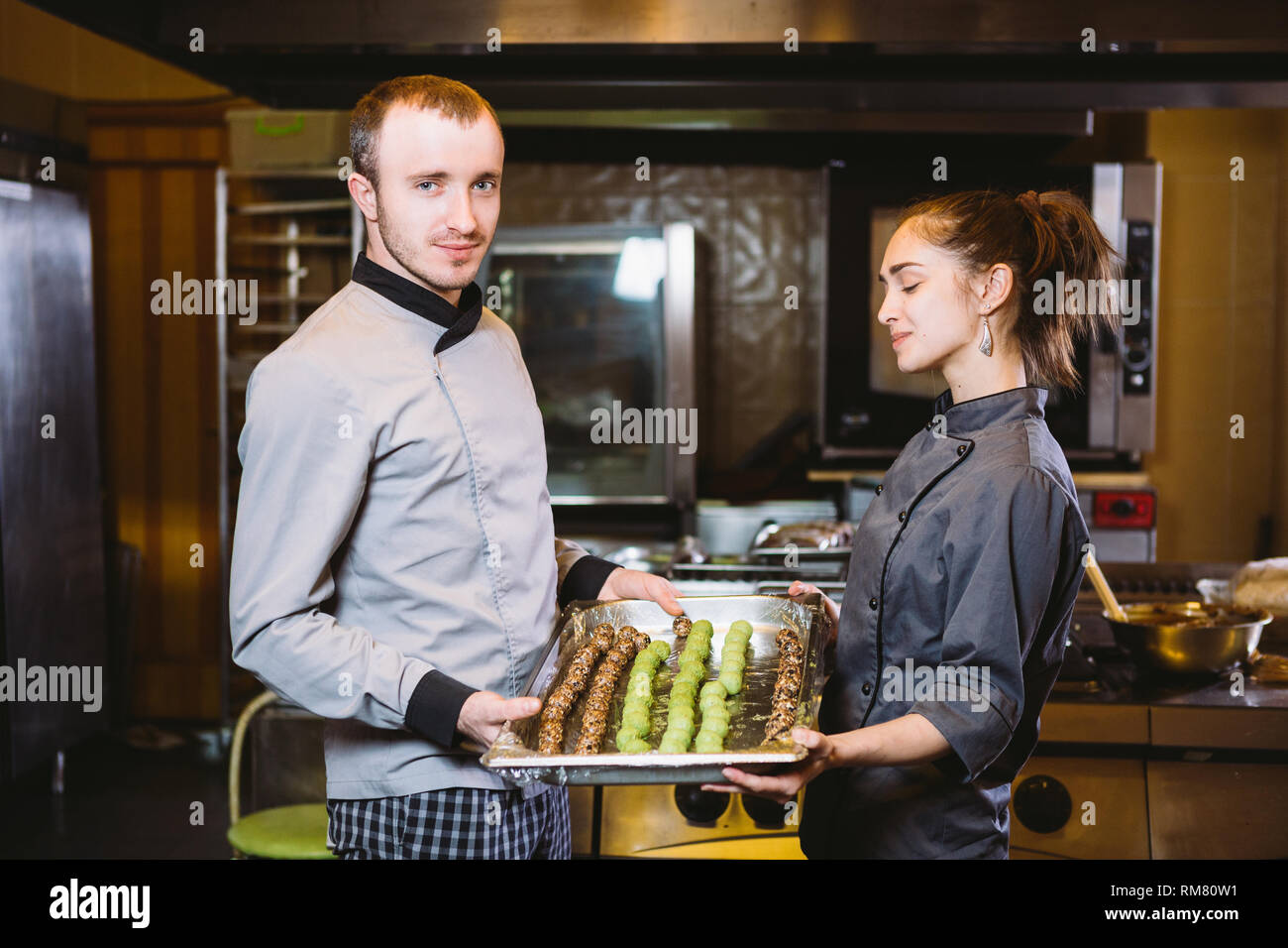profession preparation confectionery products. Caucasian man and woman ...