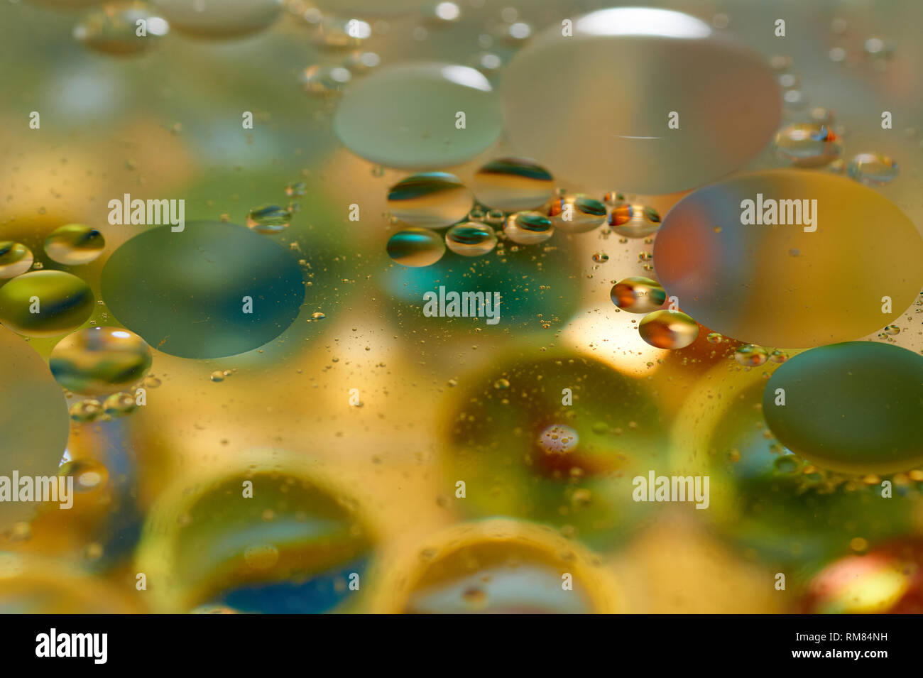 Floating In The Water Abstract Colorful, Yellow Oil Drops Stock Photo 