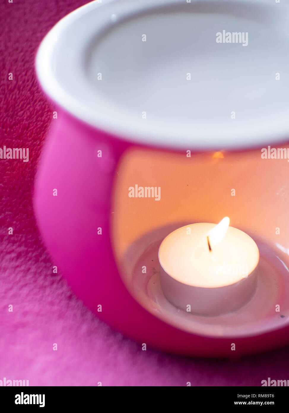 pink aromatherapy oil burners with candle, selective focus Stock Photo