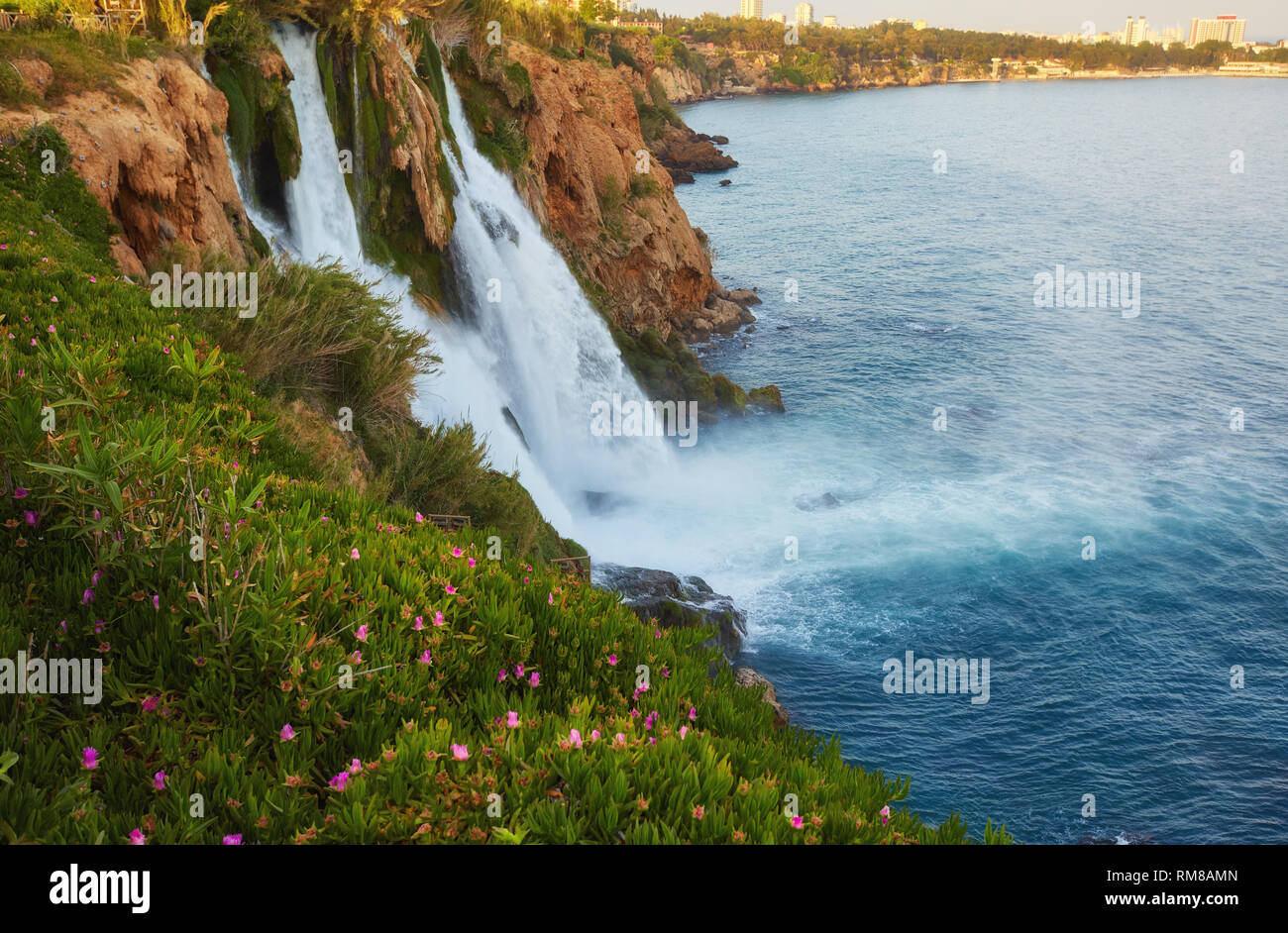 The picturesque Lower Duden Waterfall is one of the most scenic natural landmarks of the country, its strong water flow creates the colorful rainbow a Stock Photo