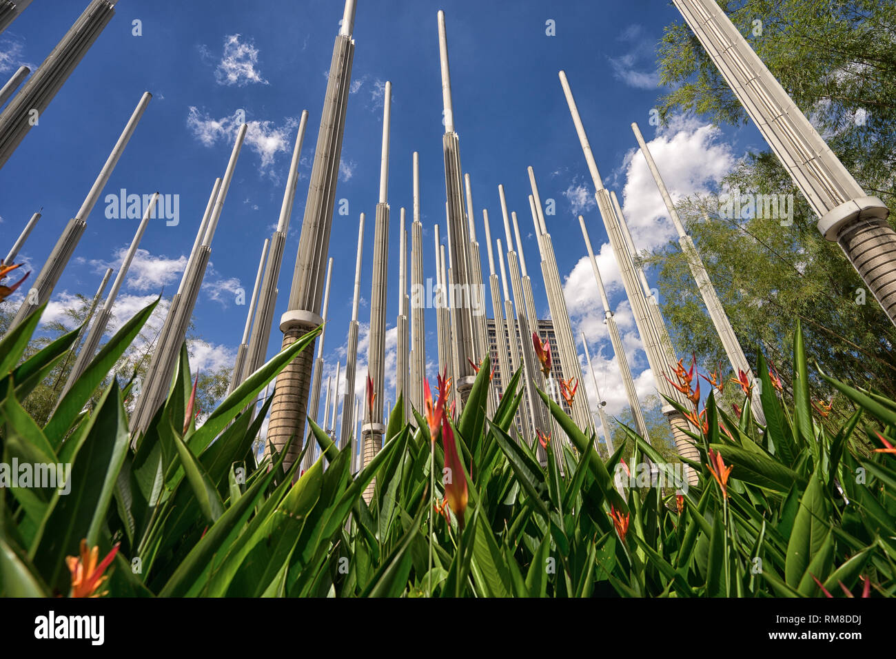 Medellin, Colombia - July 25, 2018: concrete light stands with flowers in the foreground at Plaza Cisneros Stock Photo