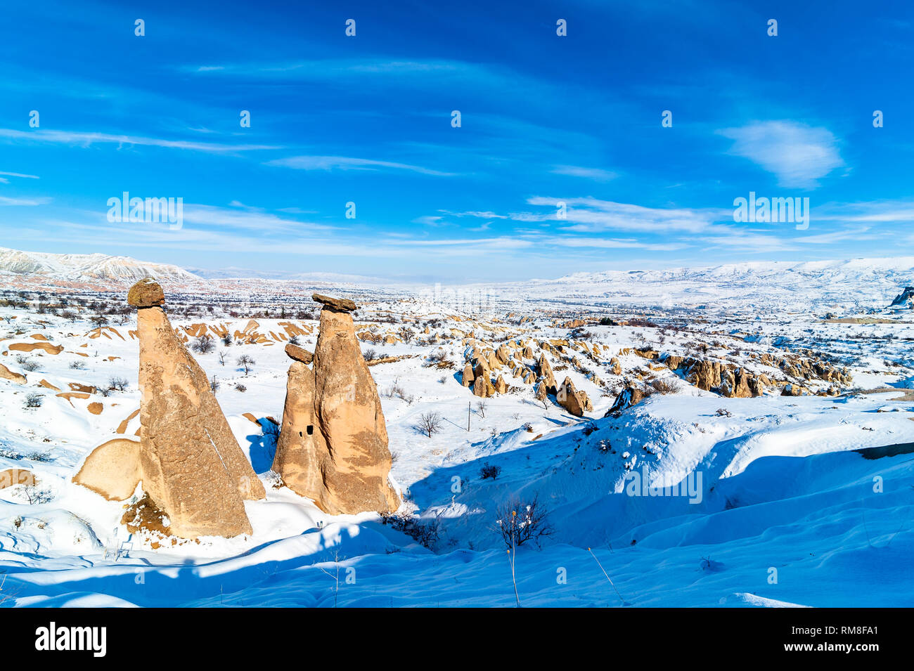 Snowy winter time at three Graces, three Beautifuls (uc guzeller) rock hills in Devrent valley Cappadocia, Nevsehir, Turkey Stock Photo