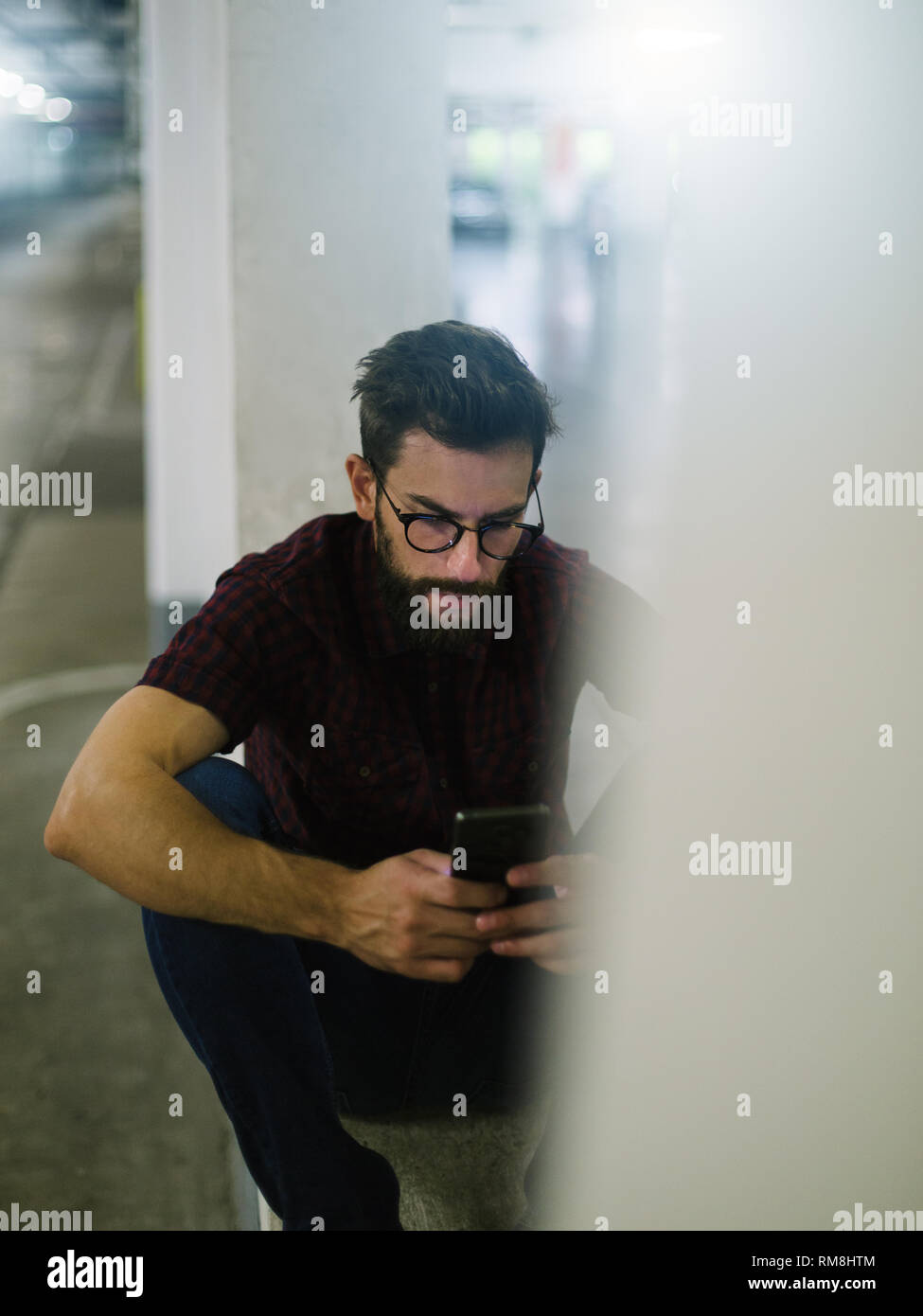 Hipster skater using smart phone in underground Stock Photo