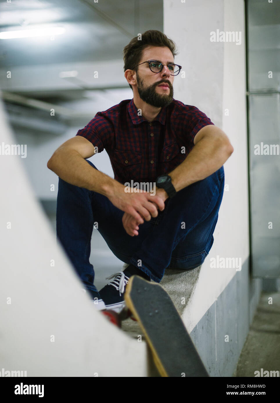 Hipster skater using smart phone in underground Stock Photo