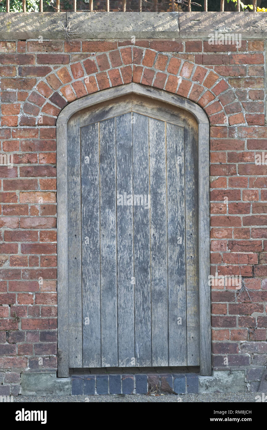 wooden door into a secret garden Stock Photo
