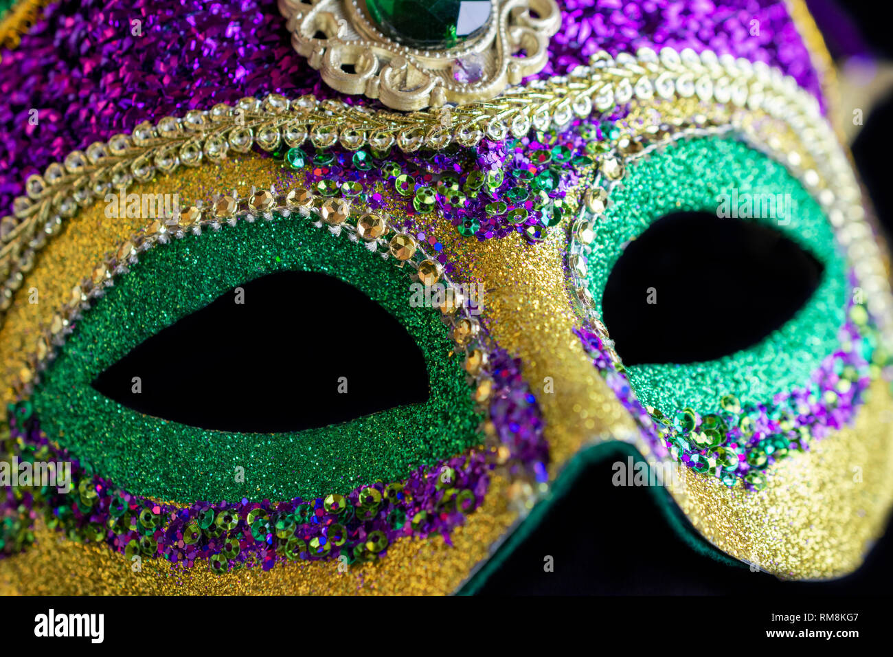 Jester mask up close against black background Stock Photo - Alamy