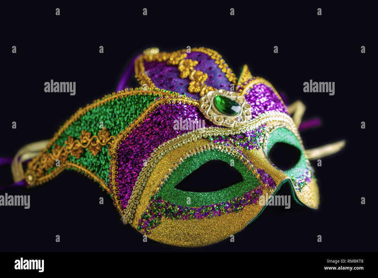 Jester mask lying on black background.  Close up view of the full mask. Stock Photo
