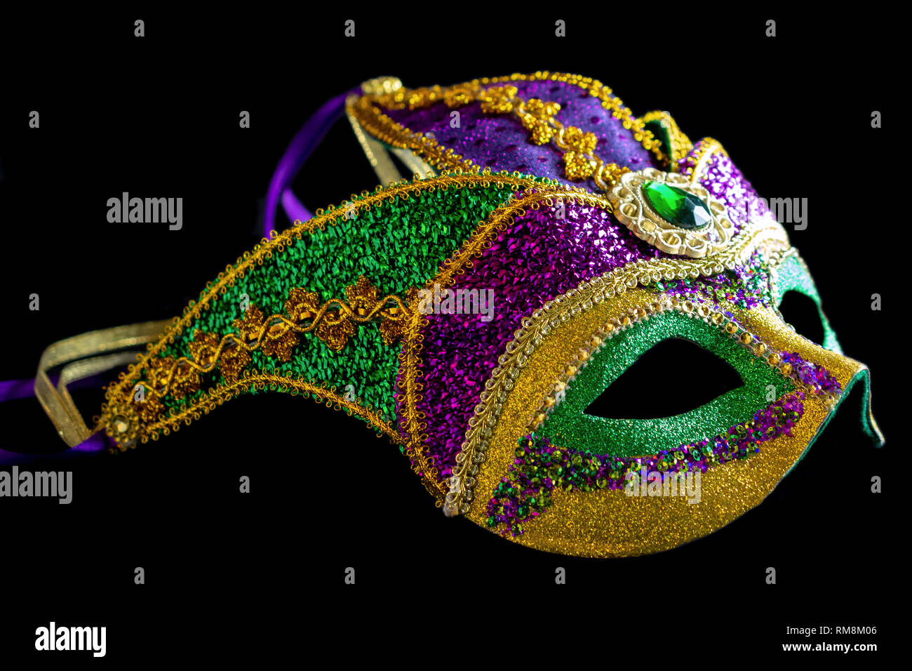 Jester carnival mask side view on black background. Stock Photo