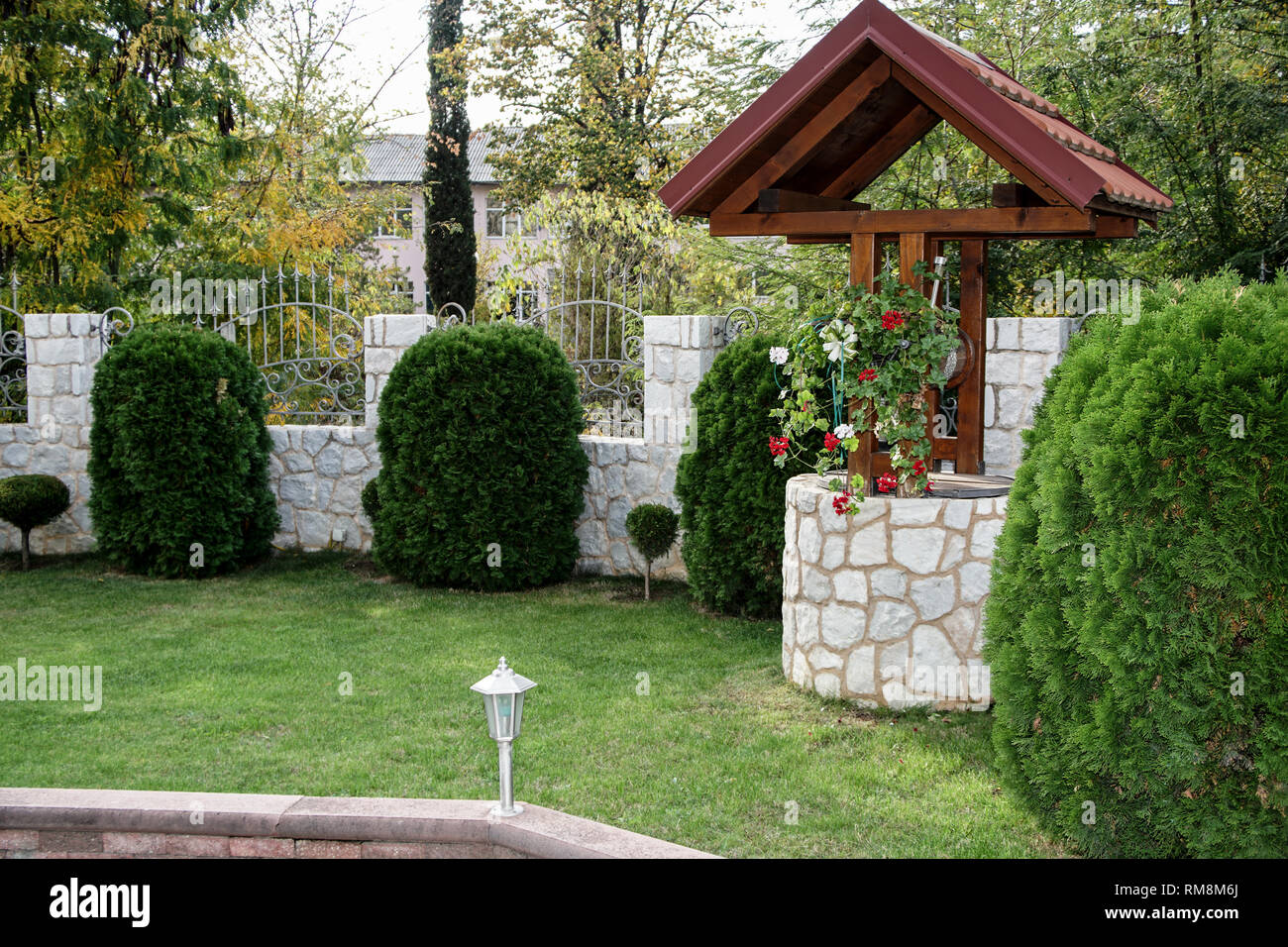 Well with a wooden roof and a bucket of water Stock Photo Alamy
